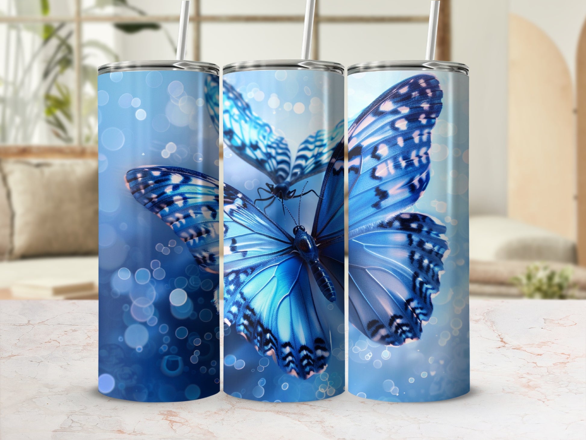 Three blue butterflies on tumblers with bokeh background.