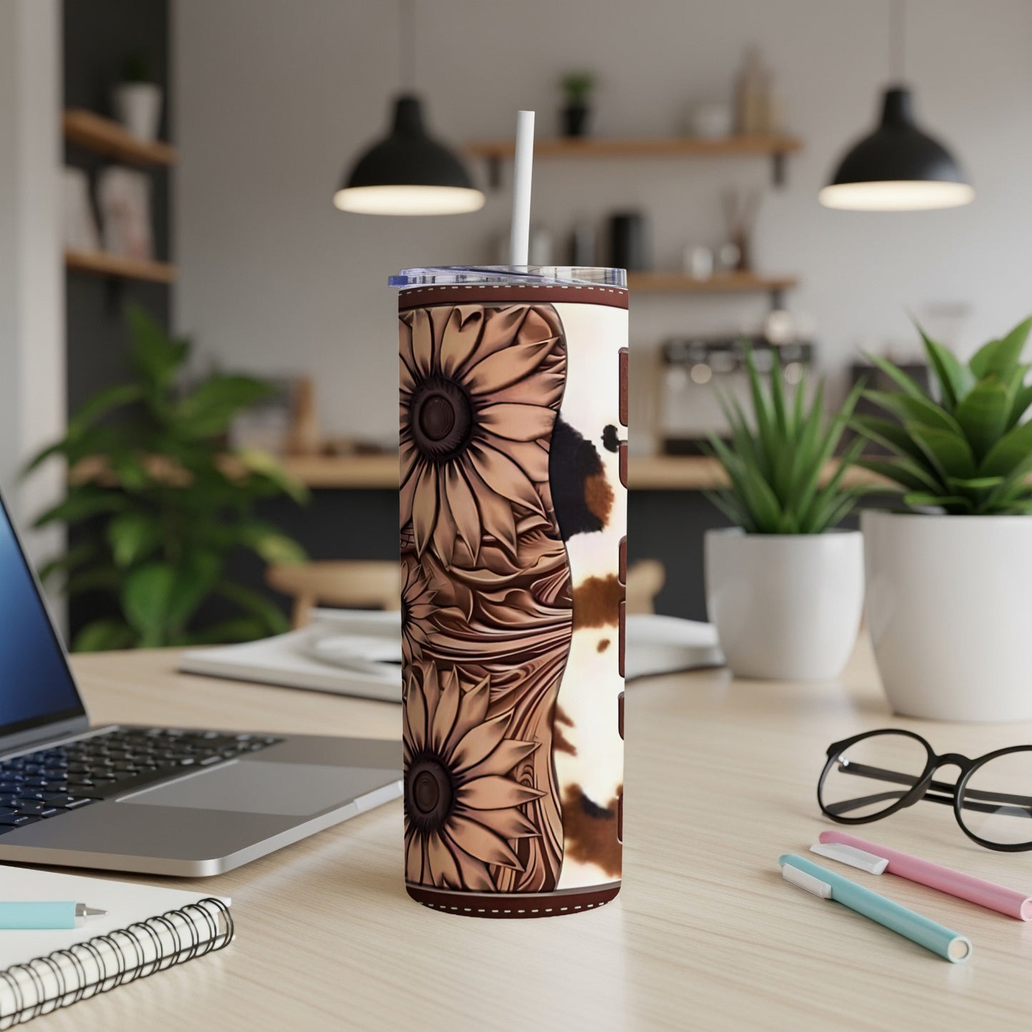 Tall tumbler with sunflowers and cow print pattern, lid and straw.