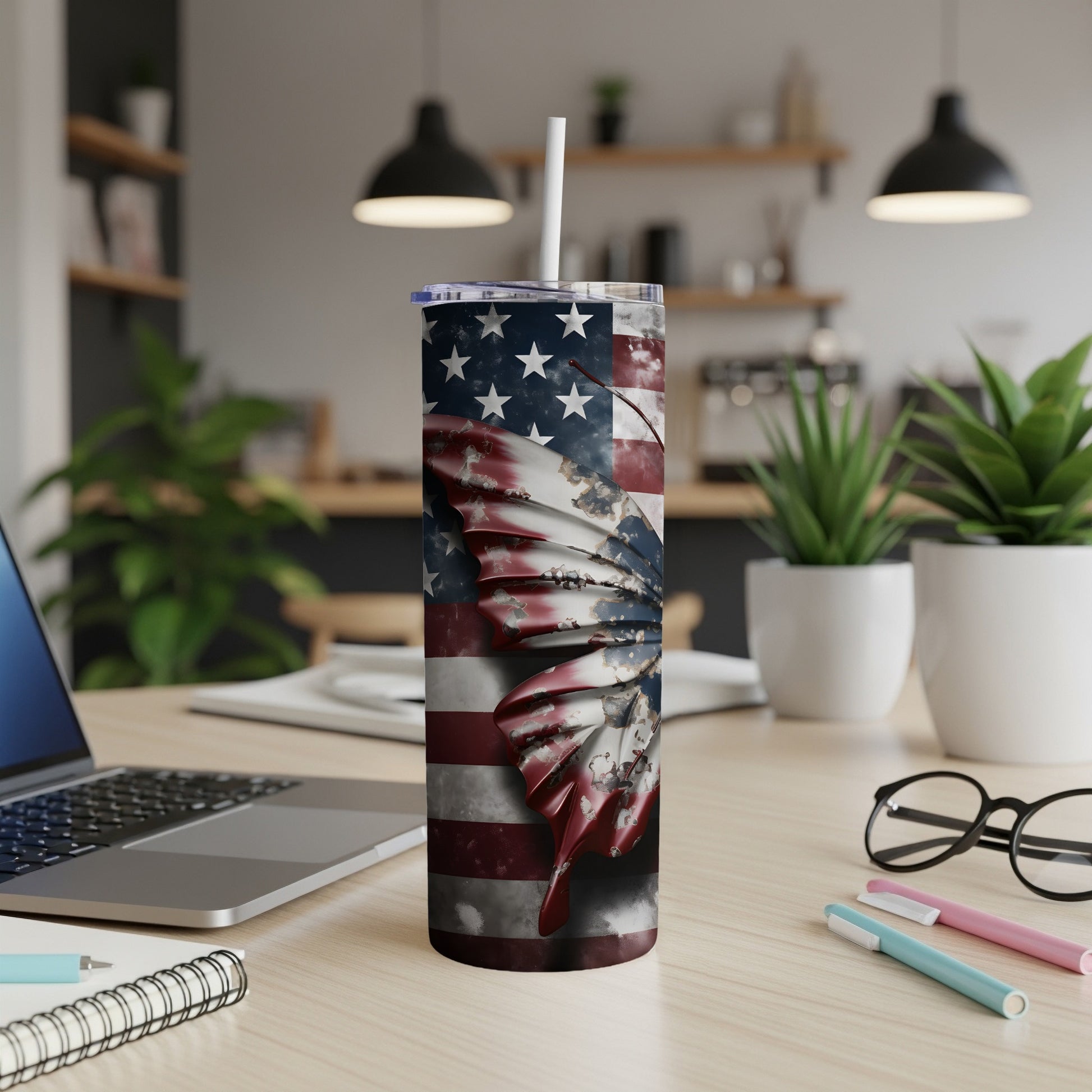 USA flag butterfly tumbler with straw on a desk.