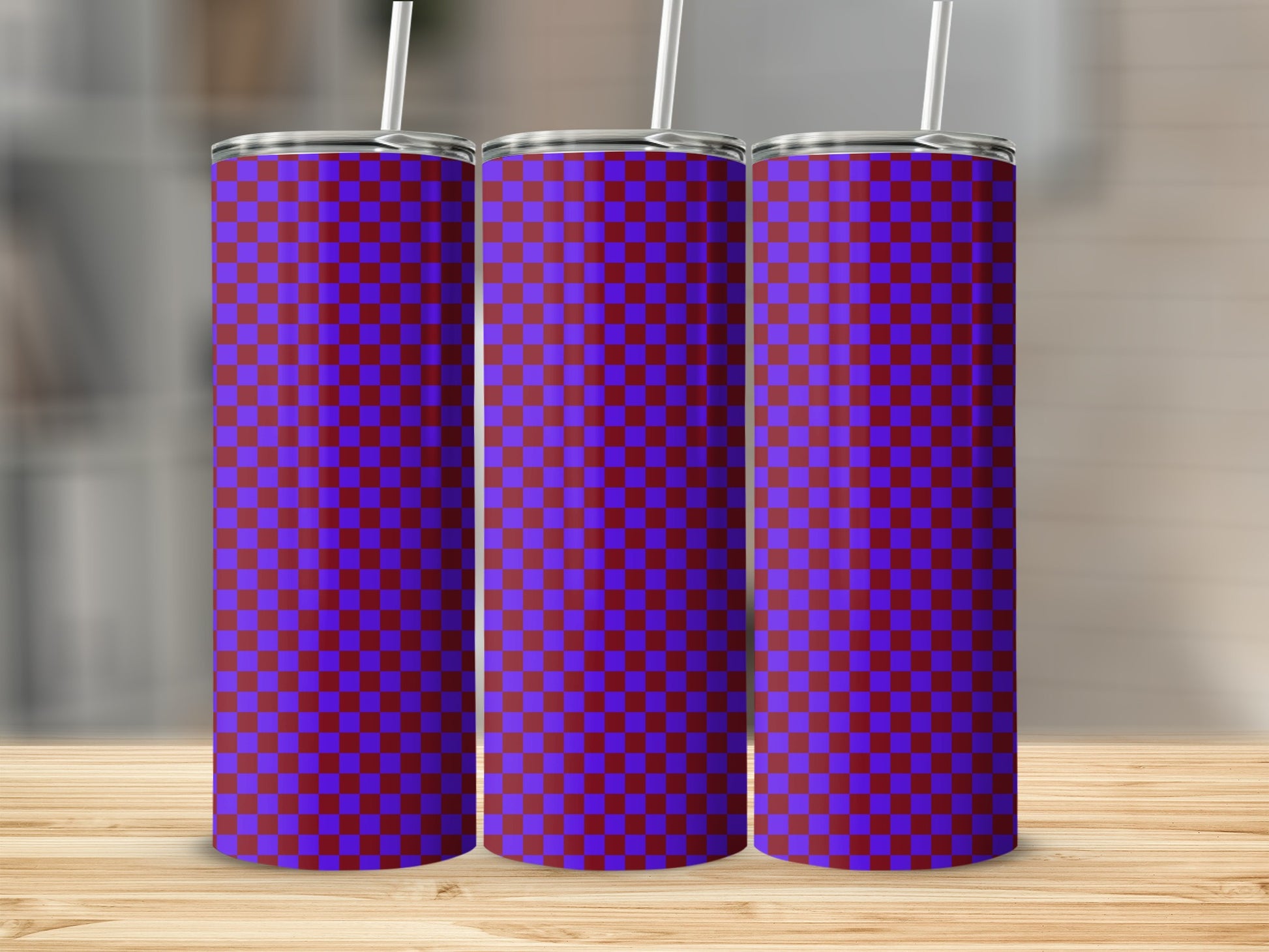 Three tumblers with a purple and blue checkered pattern stand upright.