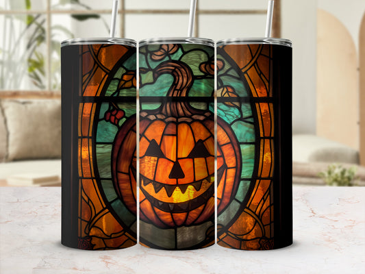 Three tumblers with stained glass pumpkin design in a window frame.