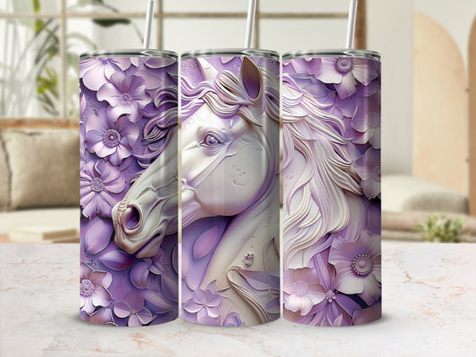 Floral unicorn tumbler with straw on marble surface.