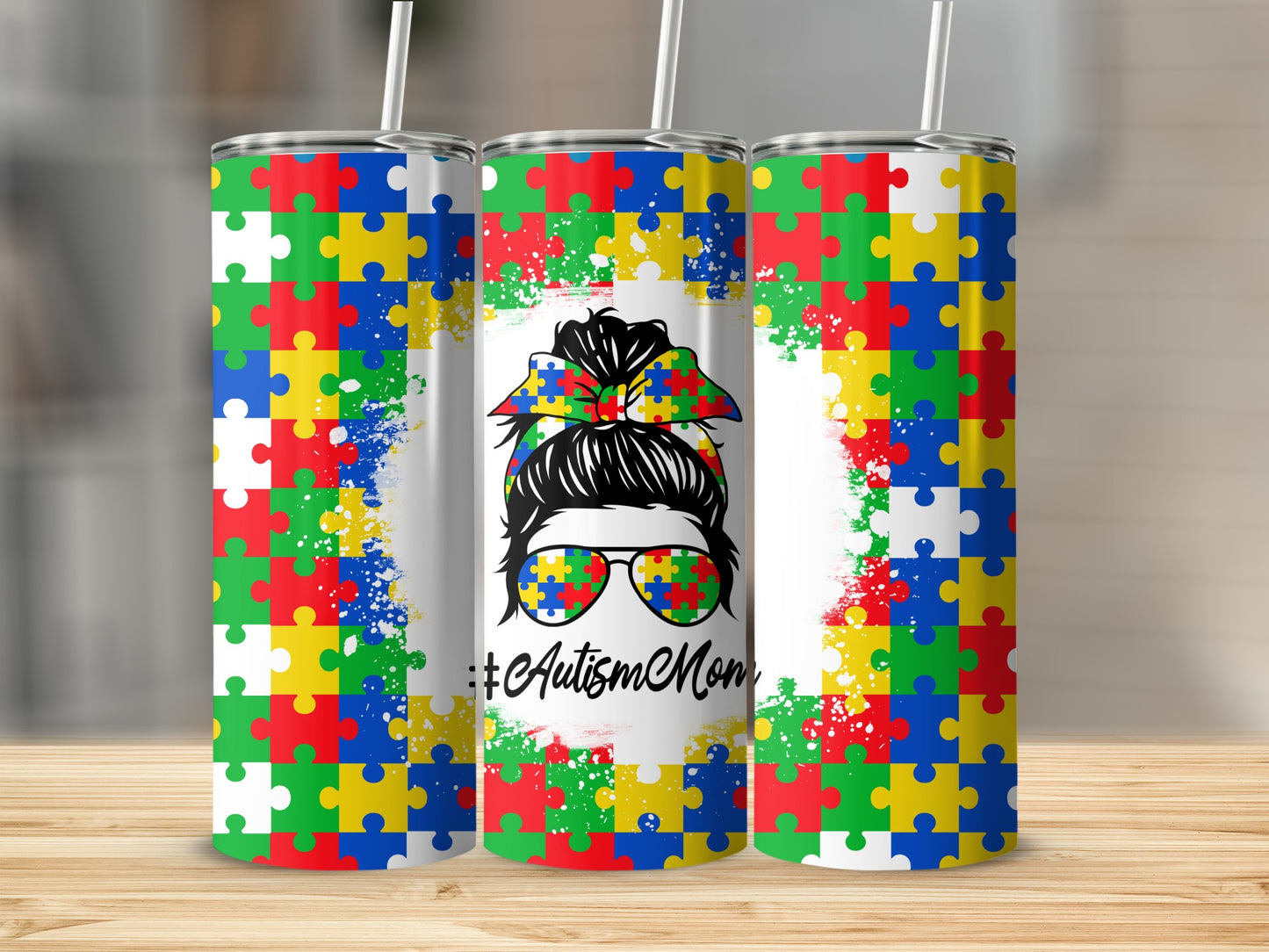 Autism Mom messy bun tumbler with puzzle piece border and white splatter.