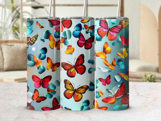 Three skinny tumblers with colorful butterflies and flower motifs.