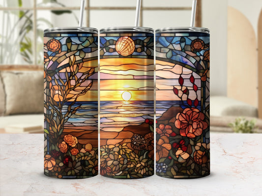 Three stained glass tumblers featuring a sunset over the ocean with floral accents.