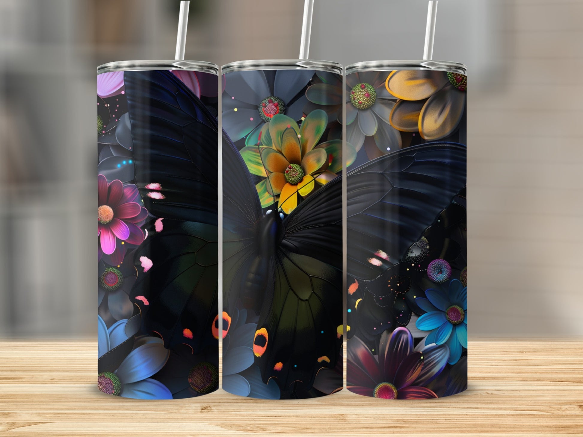 Three tumblers featuring black butterflies and colorful floral designs.
