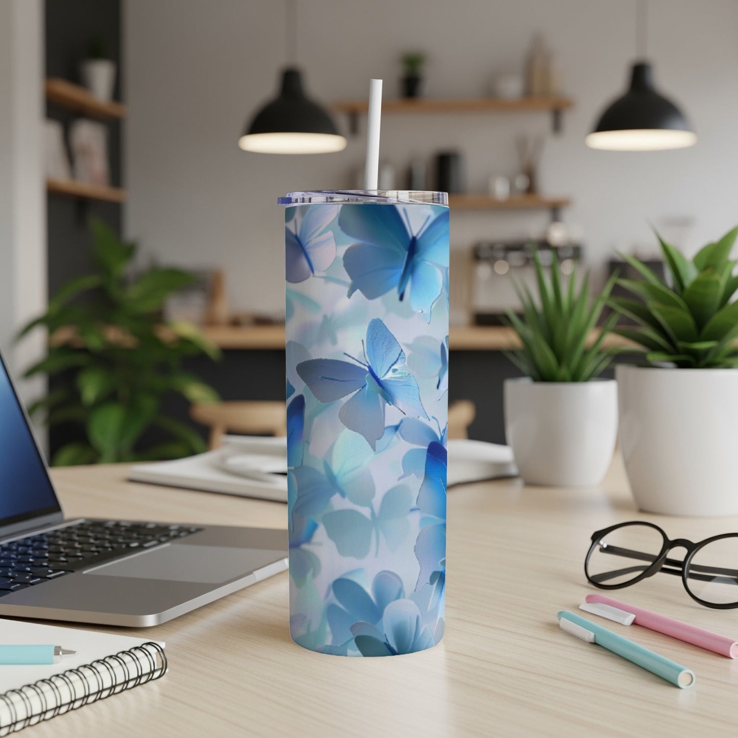 Blue butterfly pattern on a white skinny tumbler with a straw.