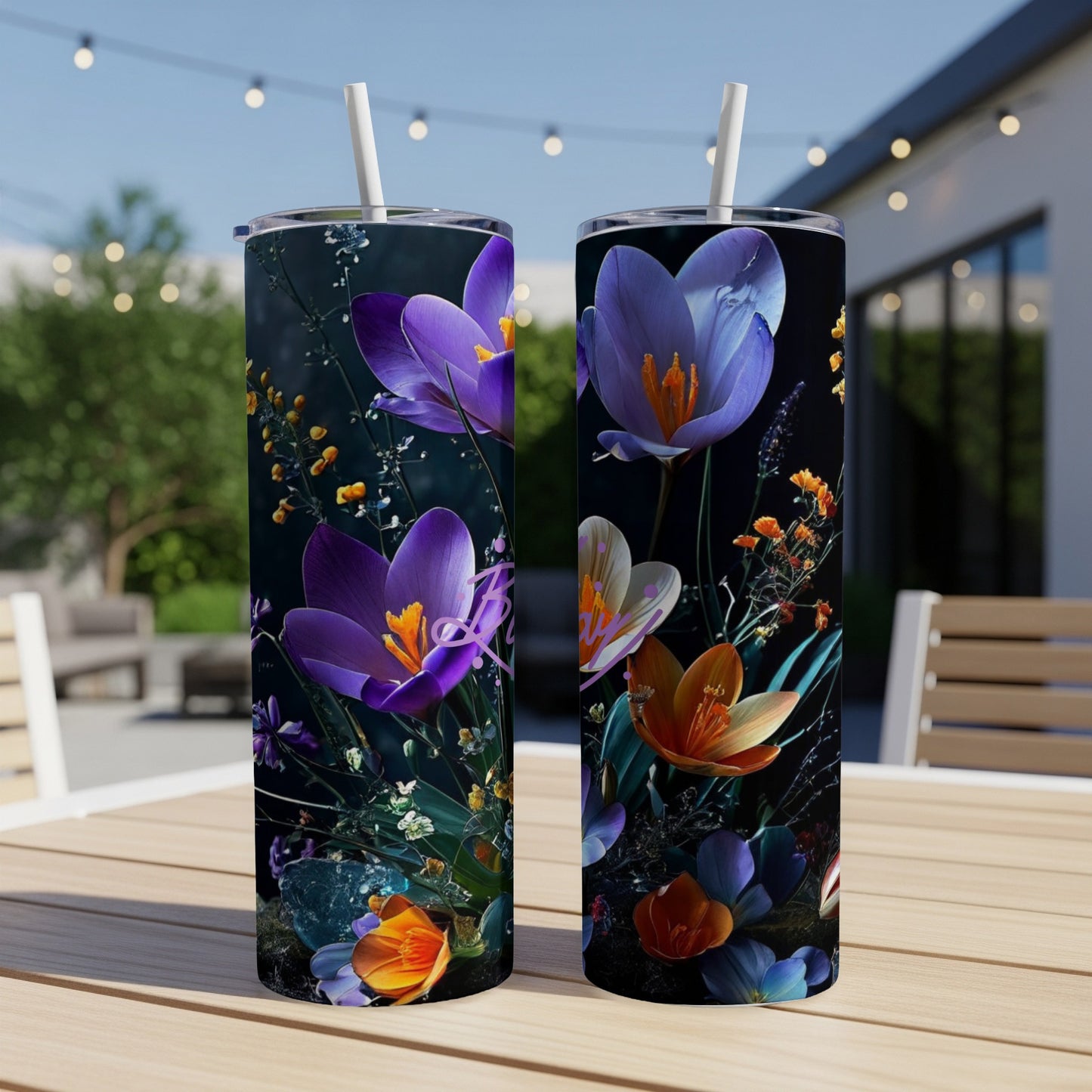 Two tumblers with purple and orange floral designs on a table.