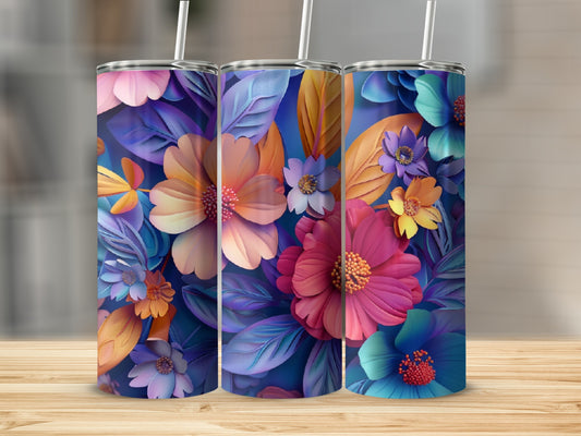 Three tumblers with vibrant floral patterns on a wooden surface.
