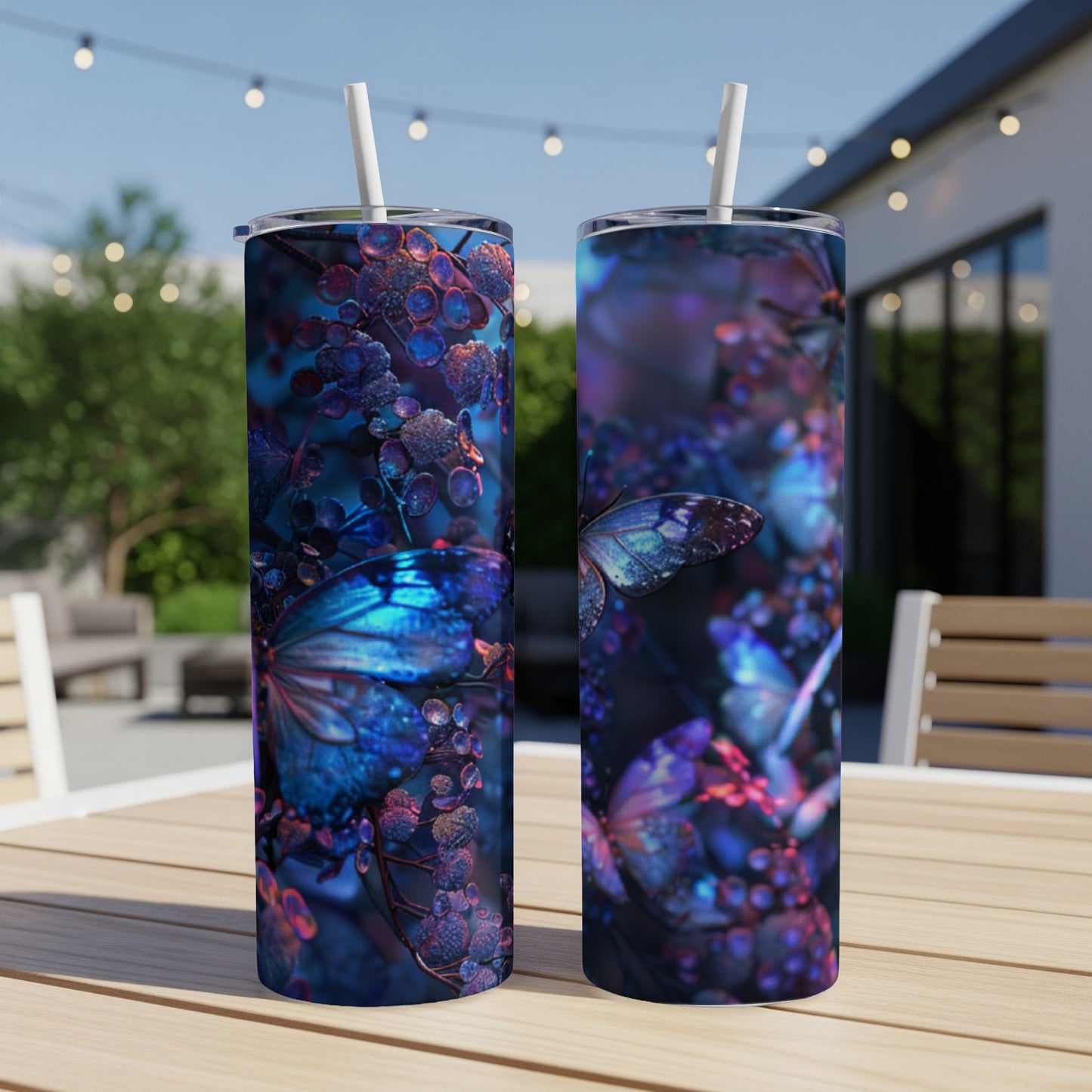 Two tumblers with iridescent blue butterflies and dark berries on a table.