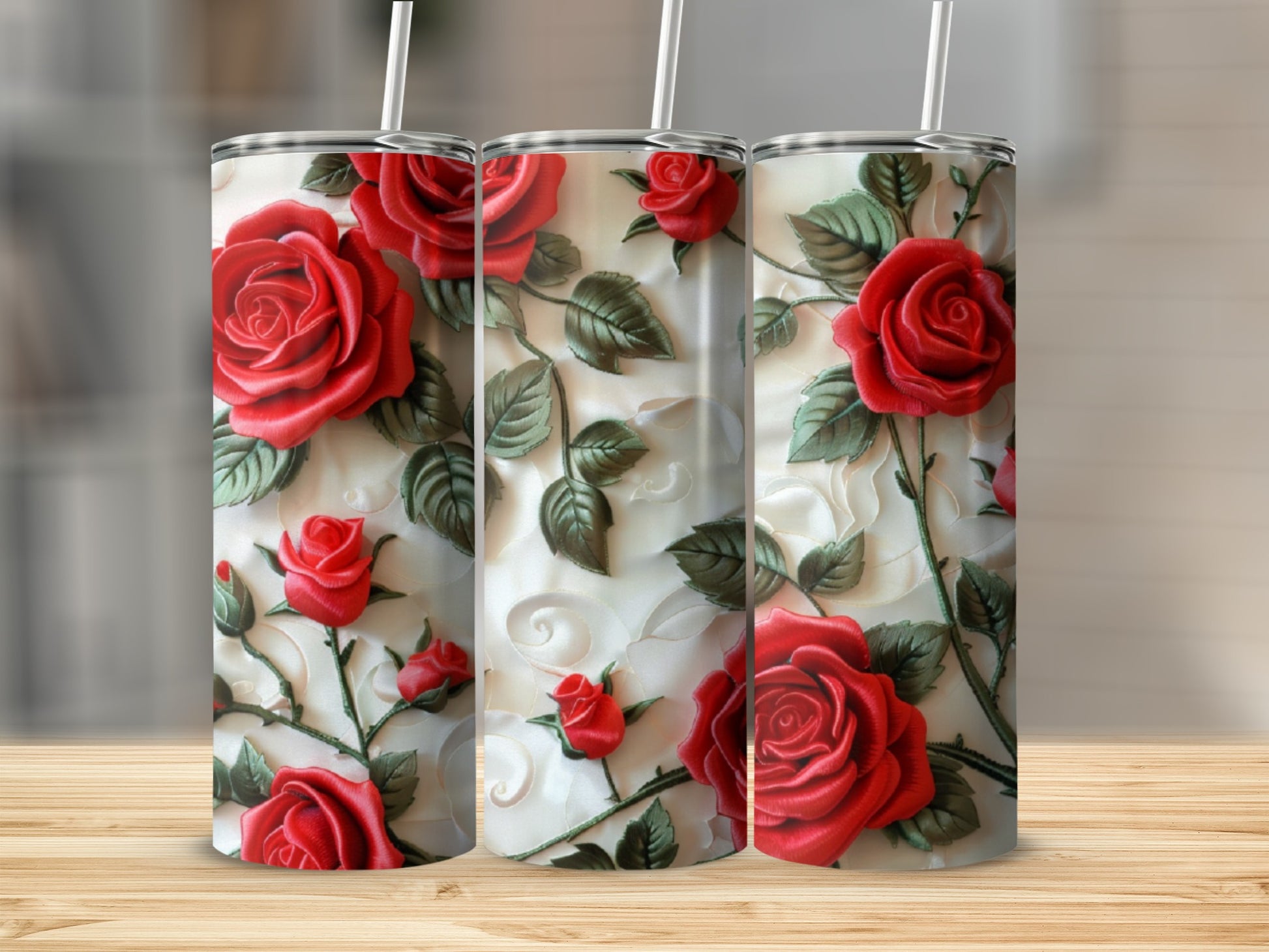 Tumbler with embossed red roses and green leaves on a textured white background.
