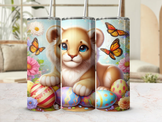 Lion cub with colorful Easter eggs and butterflies on a tumbler.
