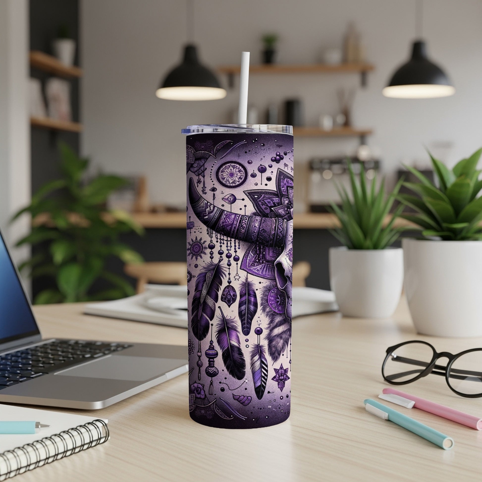 Purple tumbler with a tribal skull and feather design.