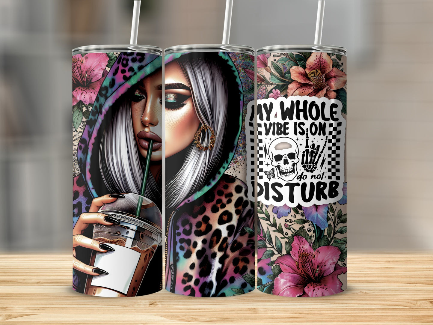 Woman with leopard hoodie and coffee, holding tumbler with skull and text.