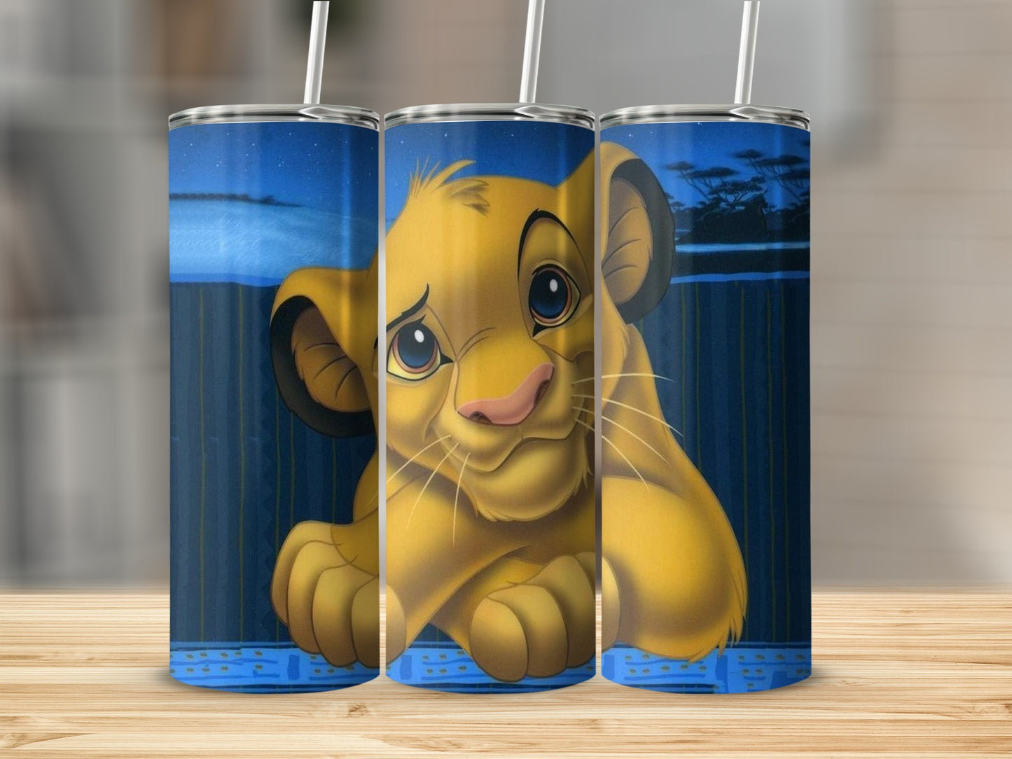 The Lion King's Simba depicted on a blue speckled tumbler with a ribbed background.