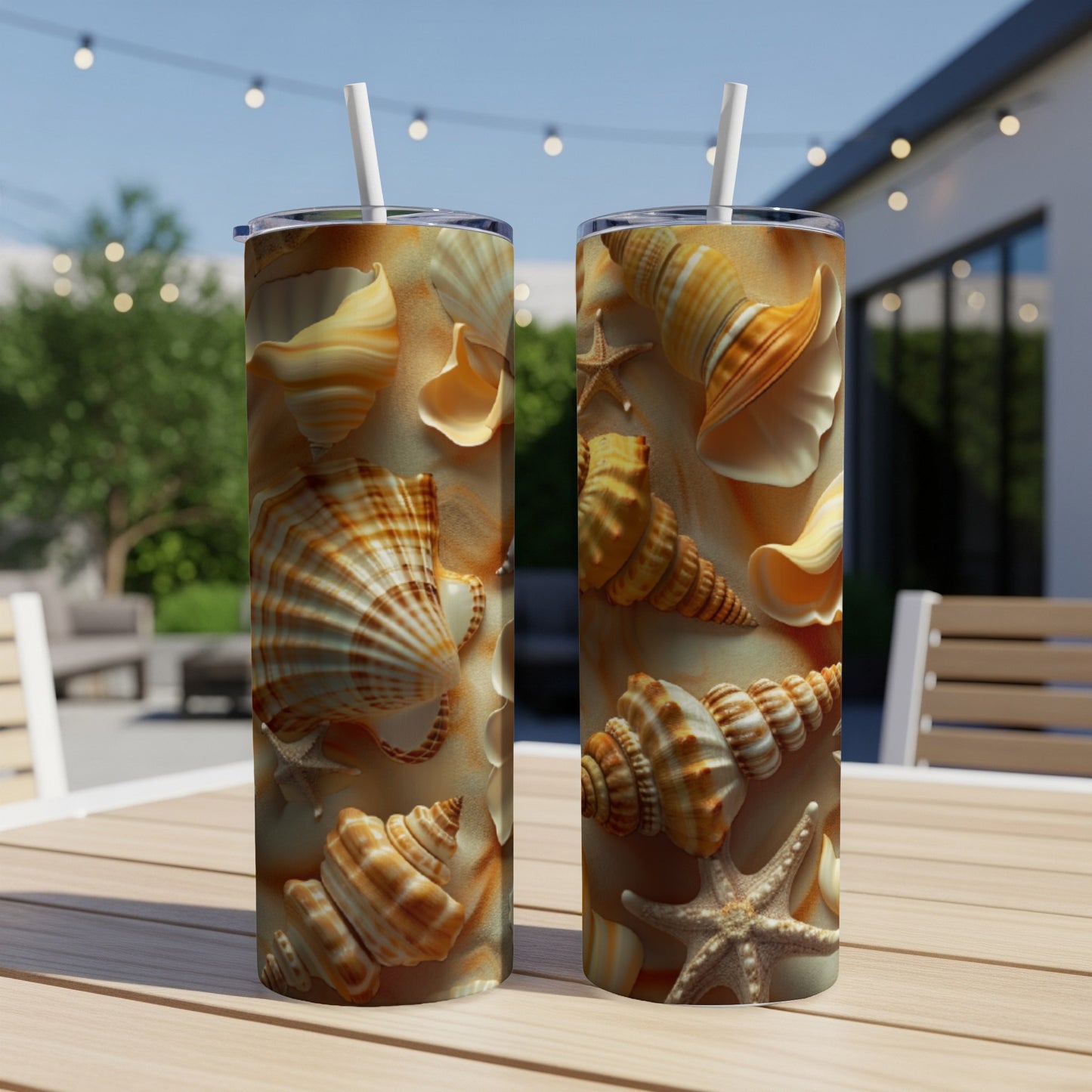 Two tall tumblers with a seashell and sand pattern, outdoors.