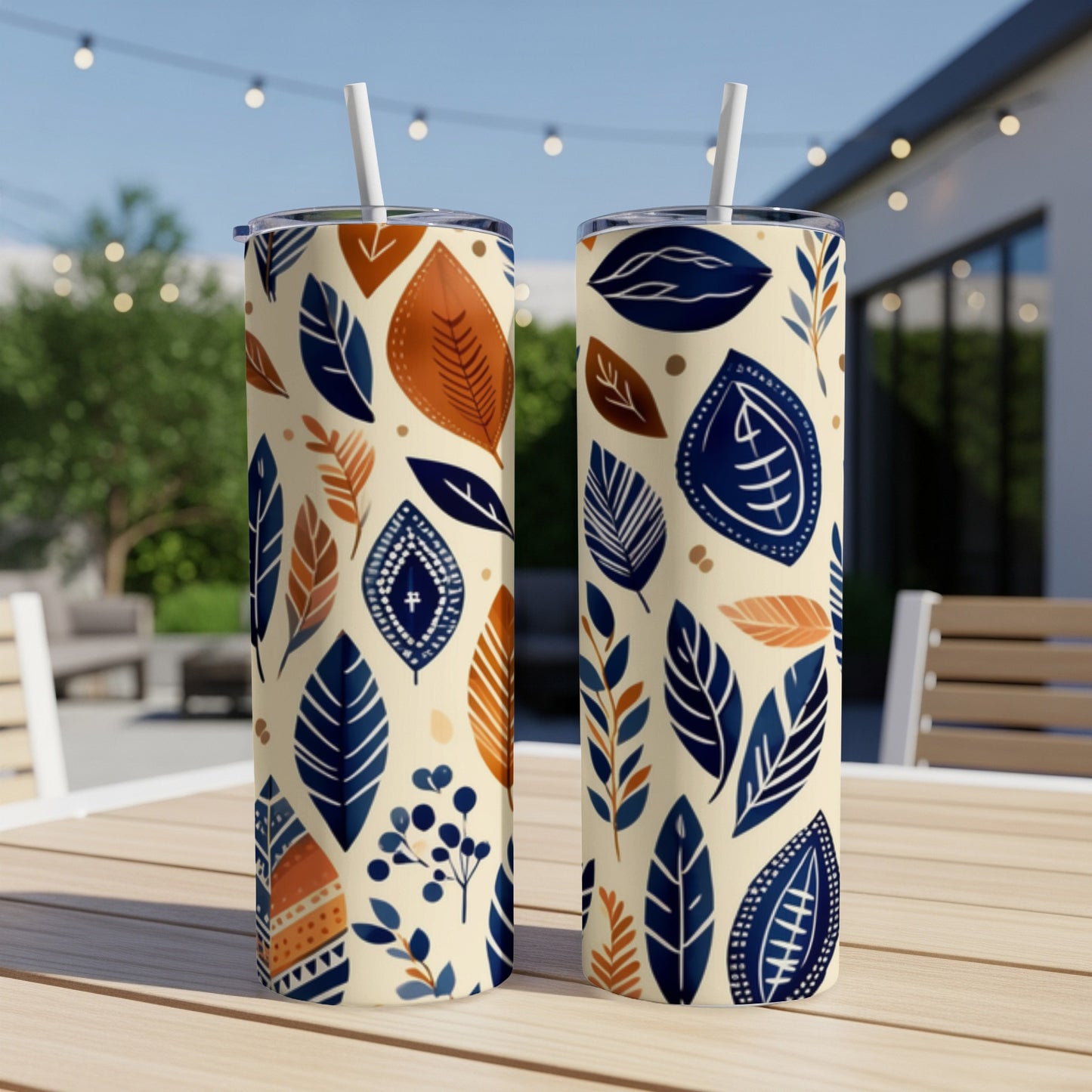 Two tumblers with a cream background and a repeating pattern of blue and orange leaves and abstract shapes.