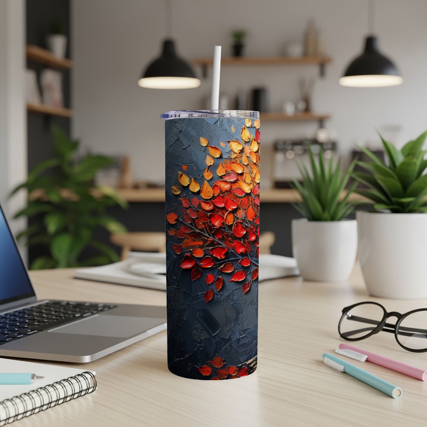 Dark tumbler with textured abstract red and orange leaves pattern.