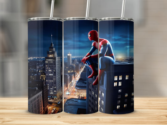 Spider-Man sitting on a building overlooking a city at night.