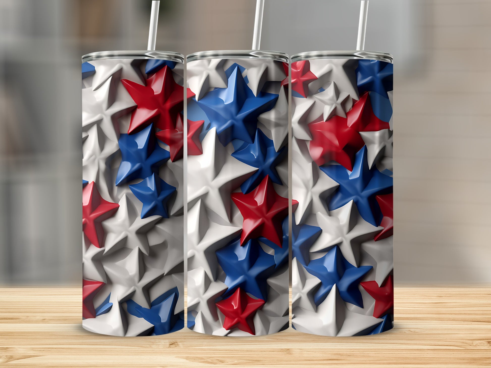 Three tumblers with a red, white, and blue star design on a wooden surface.