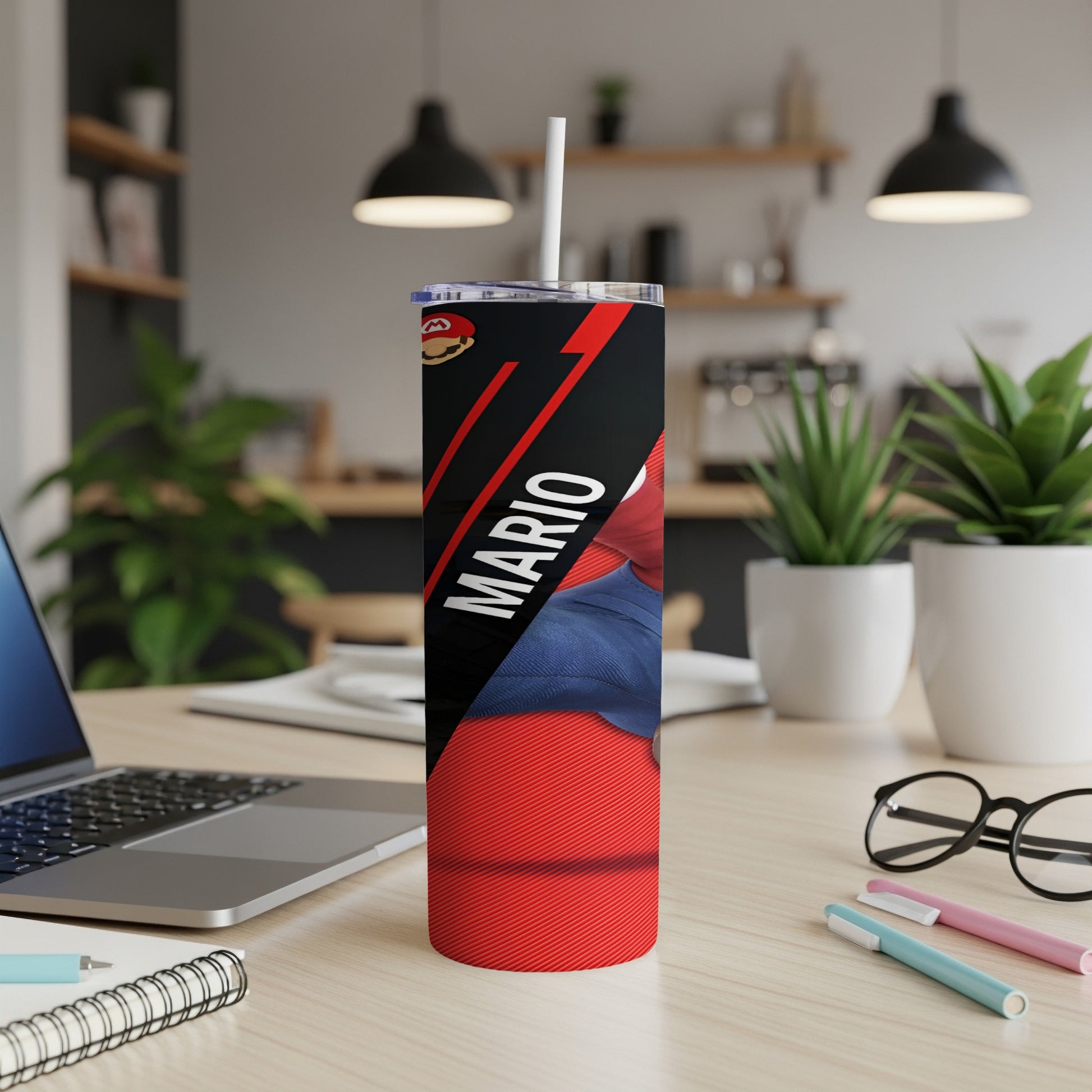Red tumbler with Mario graphic and white straw on a desk.