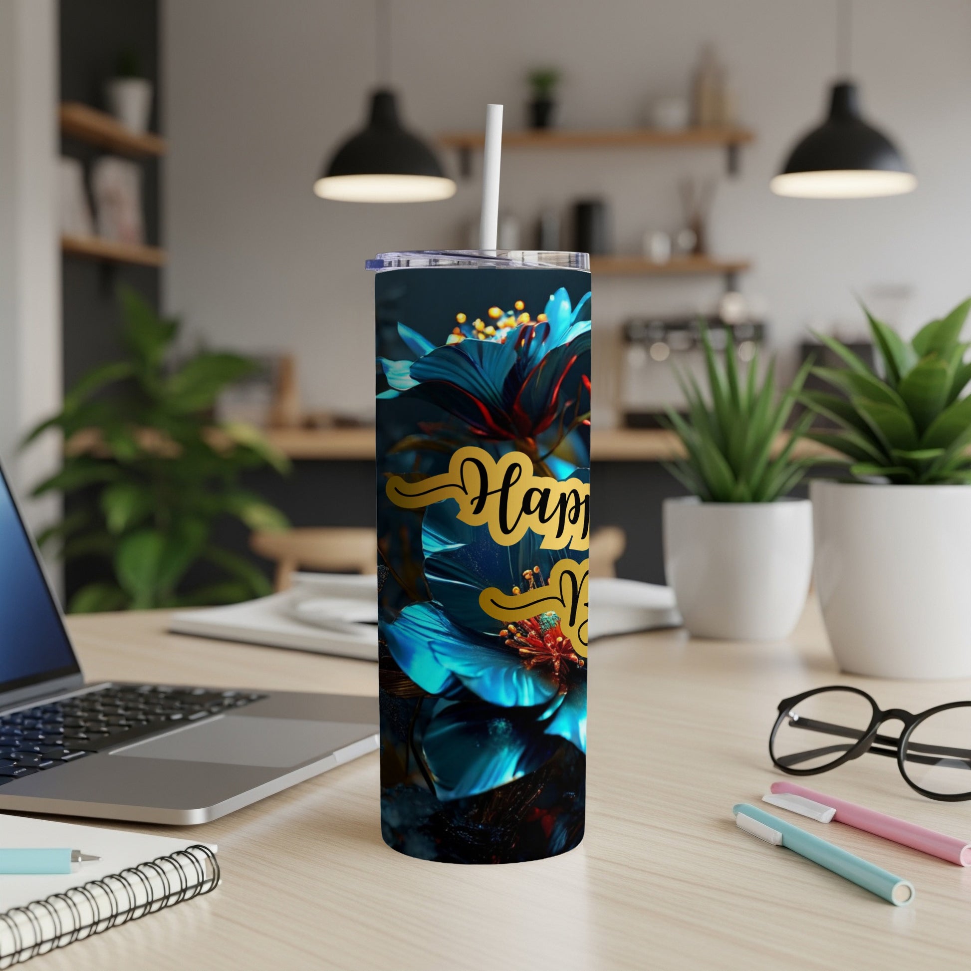 Blue floral tumbler with "Happy Mother's Day" text on a desk.