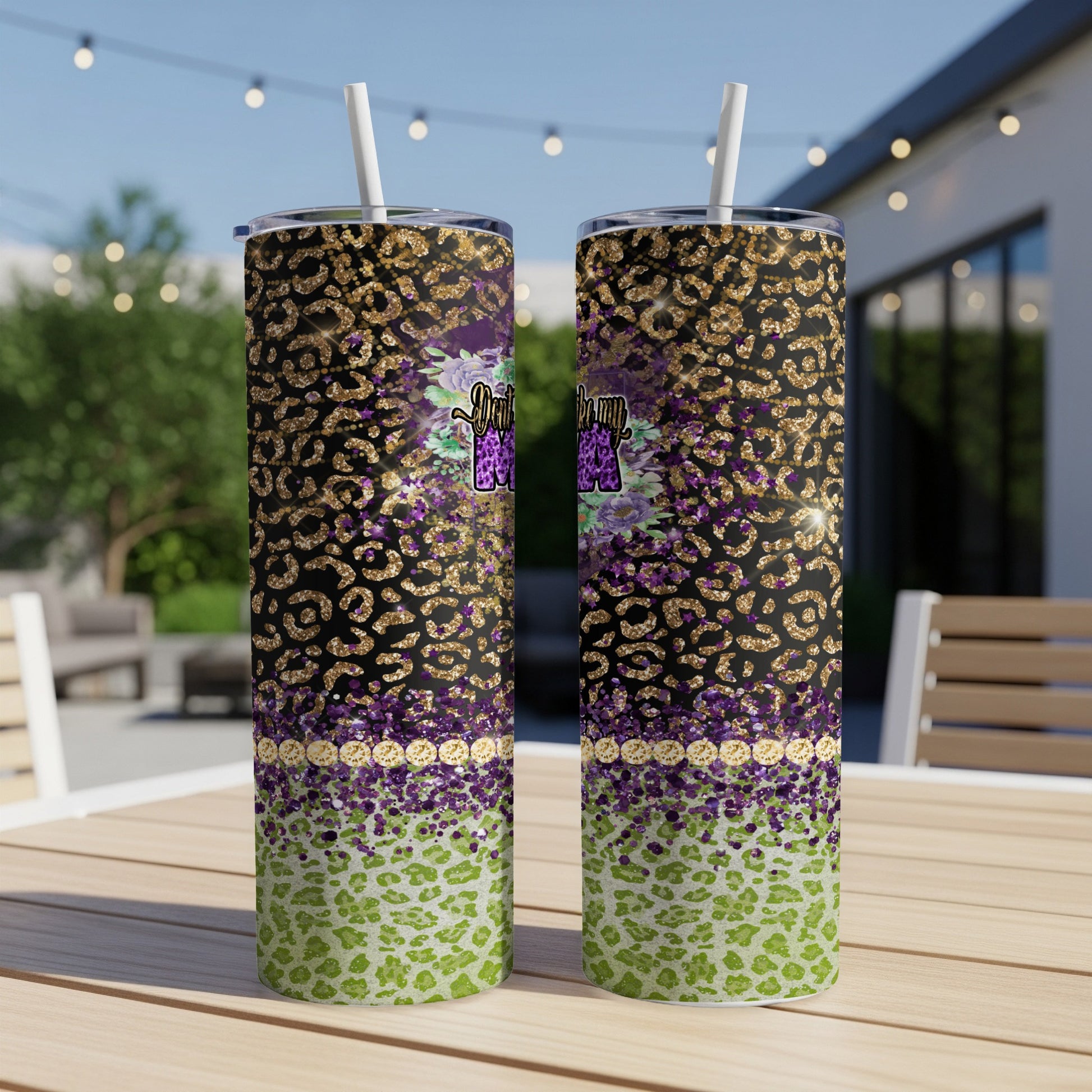 Two tall tumblers with leopard print, glitter, and floral designs.