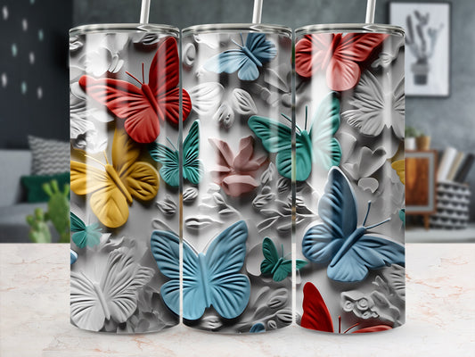 Three tumblers with raised butterfly designs in red, yellow, and blue.