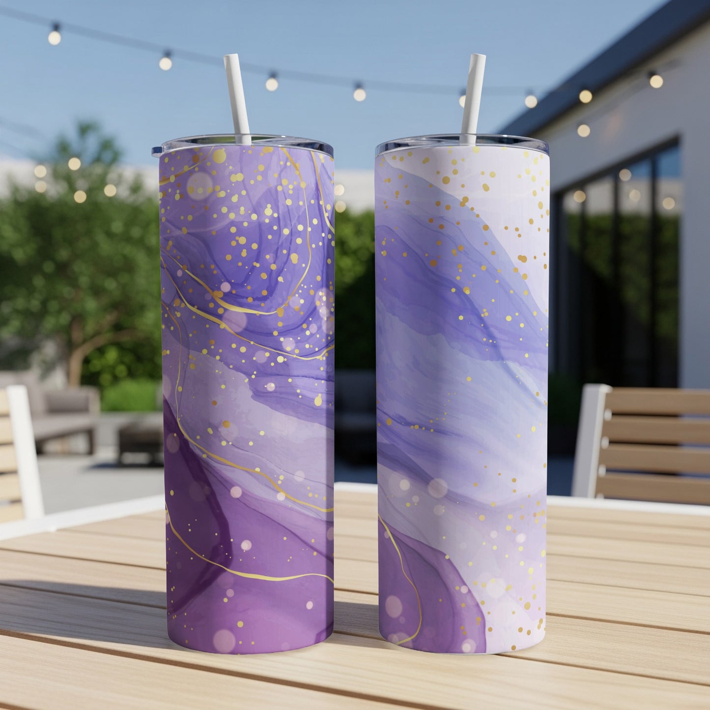 Two purple and white tumblers with gold glitter accents on a wooden table.