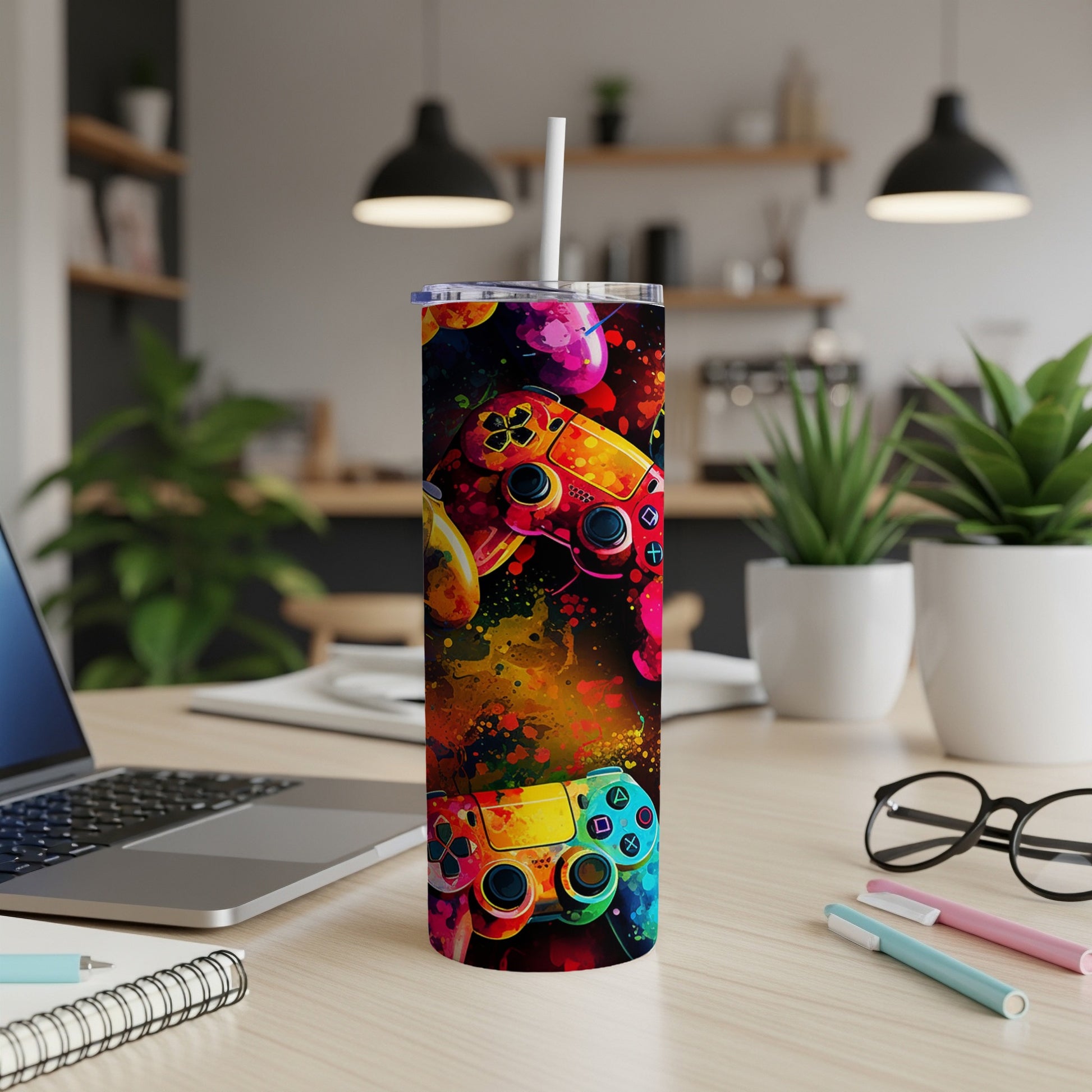 Colorful game controllers adorn a stainless steel tumbler on a wooden desk.