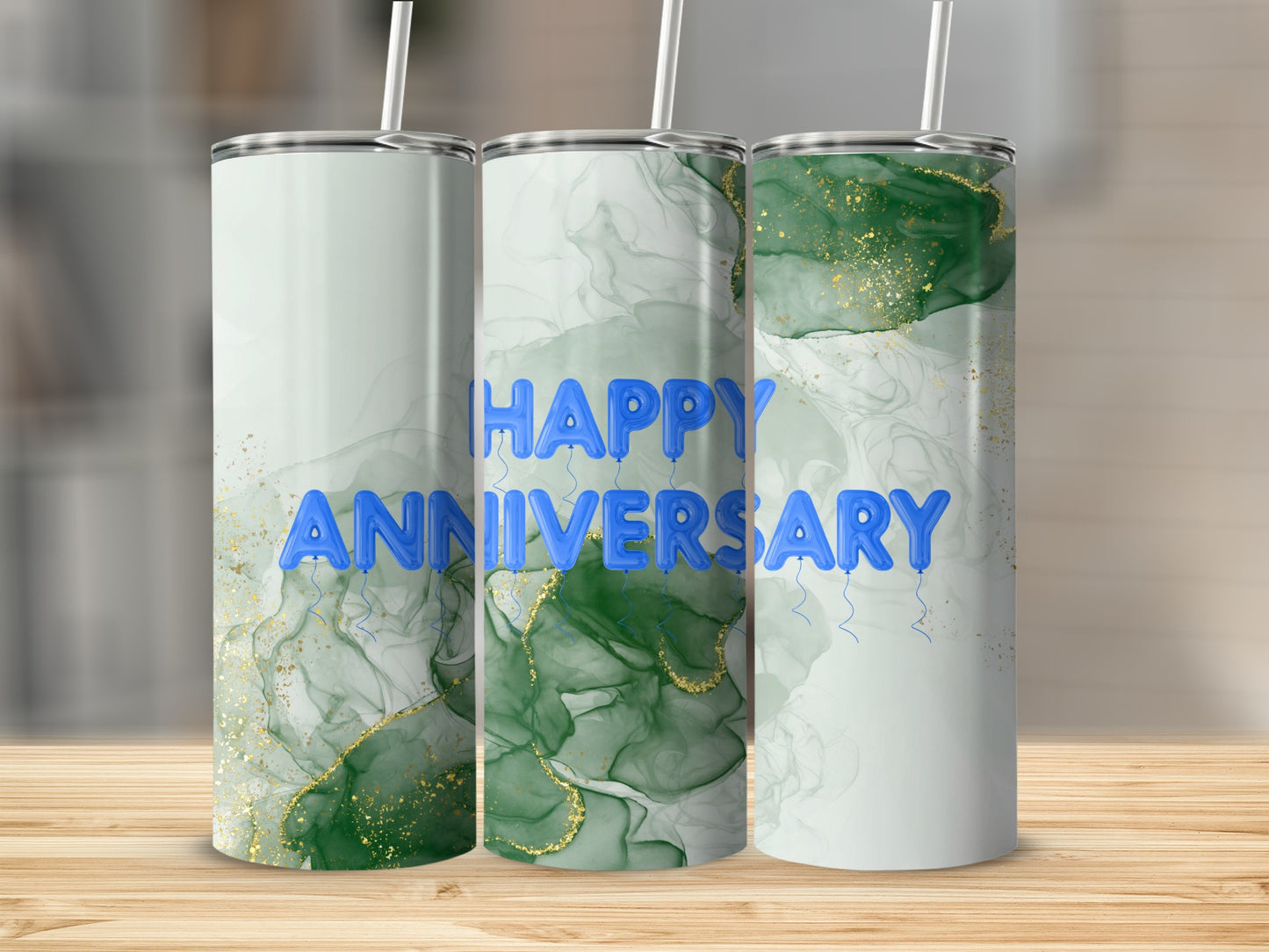 Tumbler with "Happy Anniversary" in blue balloons and green marble design.