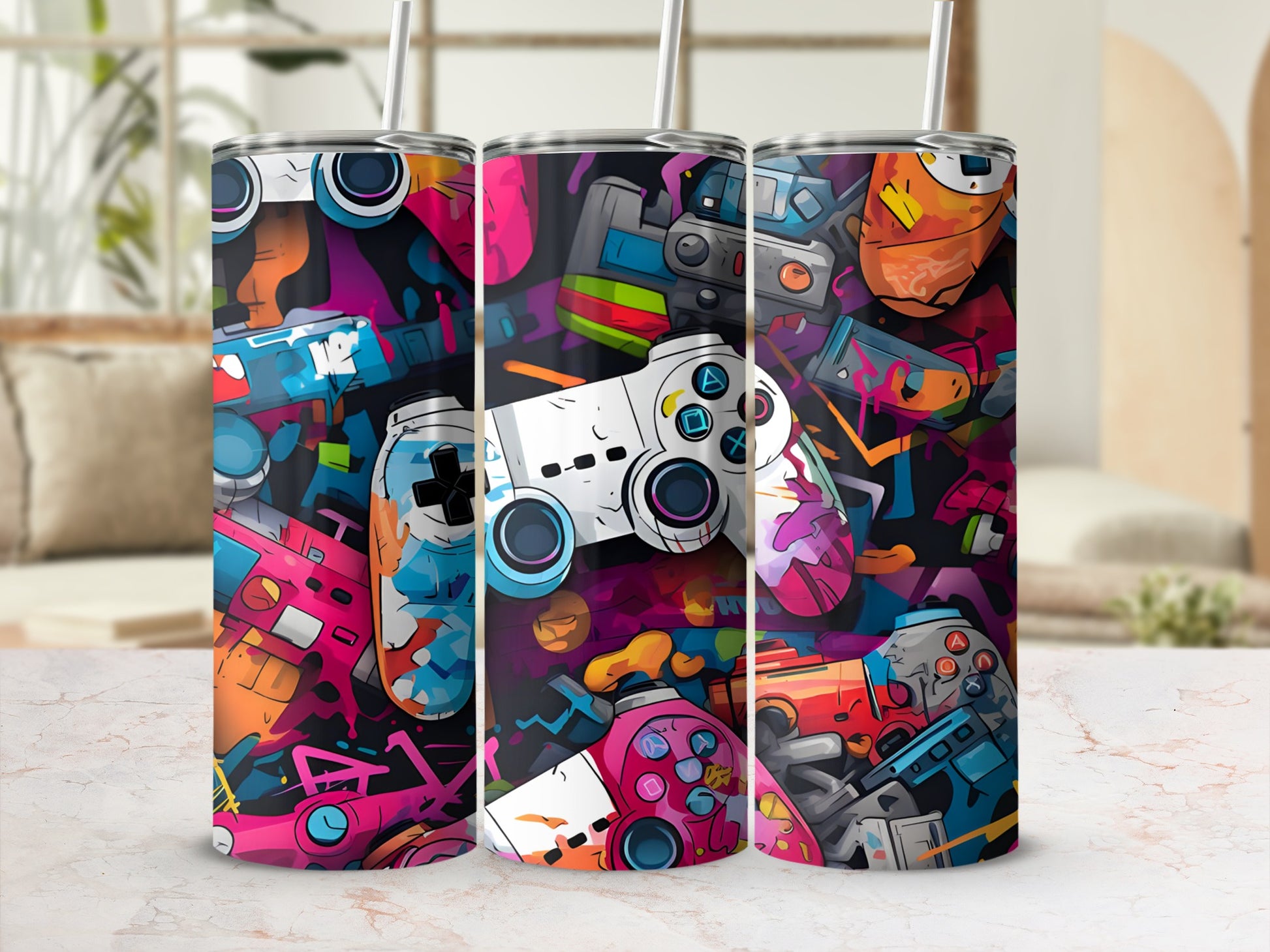 Three tumblers with colorful, abstract video game controller designs.