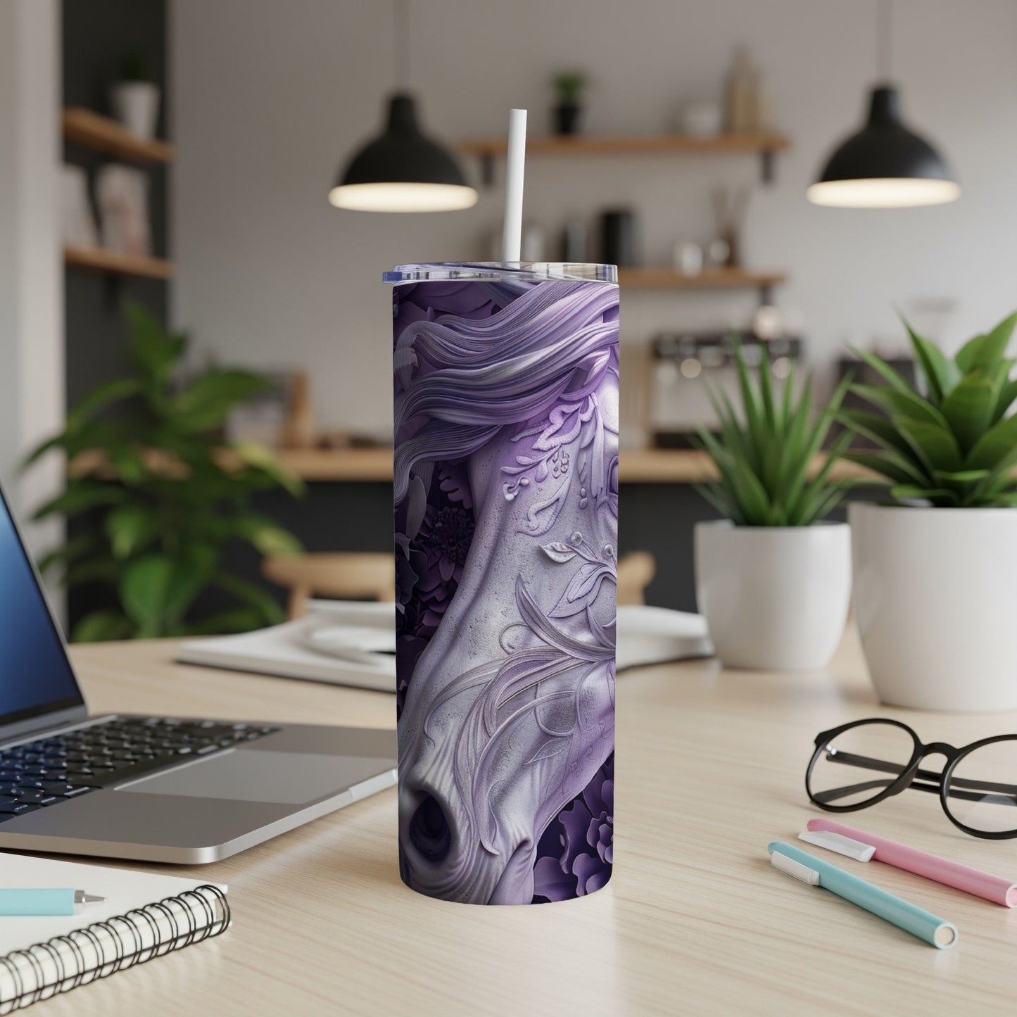 Purple tumbler with intricate horse design on a desk.