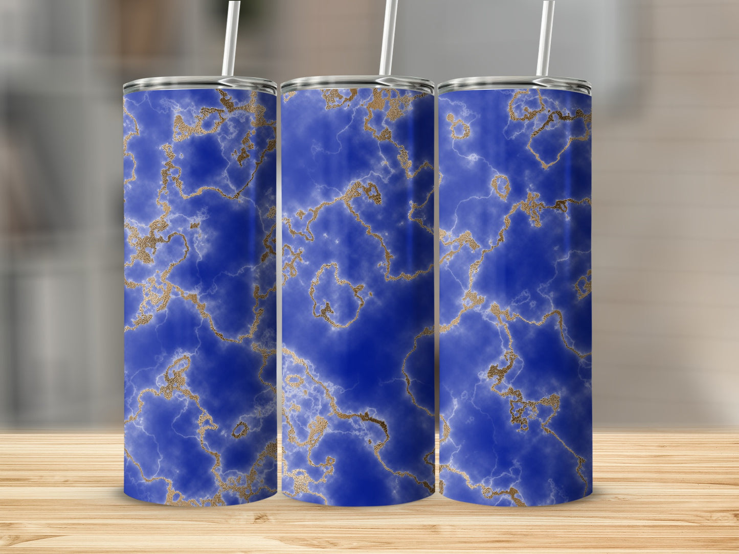 Three blue marble tumblers with gold veins, standing on a wooden surface.