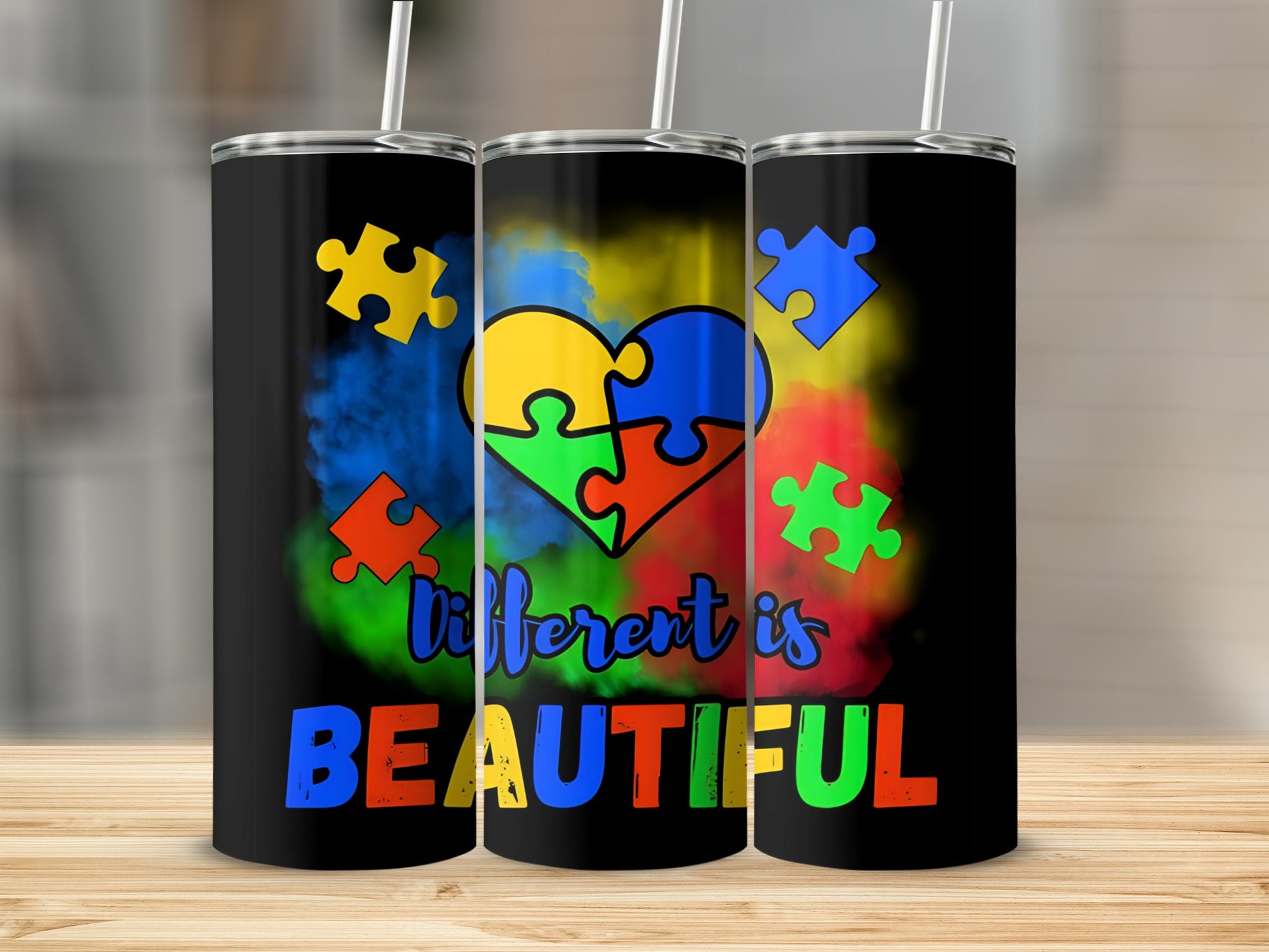 Black tumbler with colorful puzzle heart and "different is BEAUTIFUL" text.