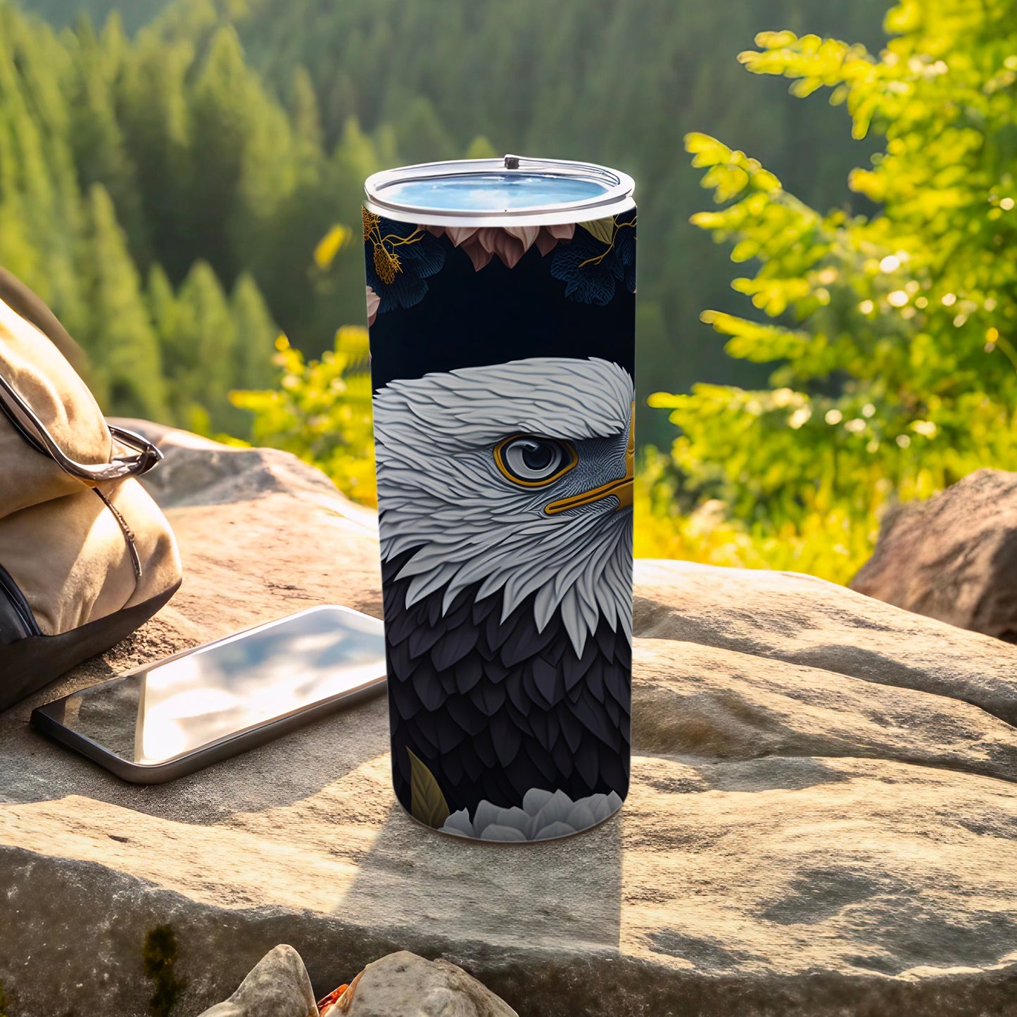 Tumbler with detailed eagle head design on a dark background, outdoors.