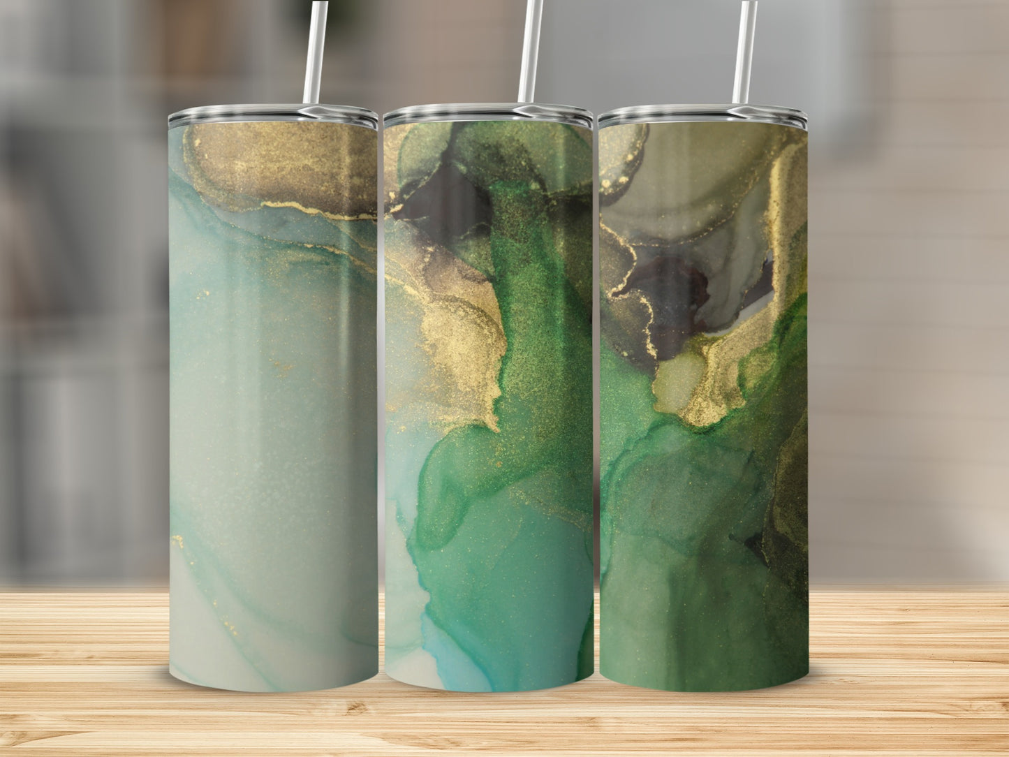 Three tumblers with abstract green and gold marbled designs.