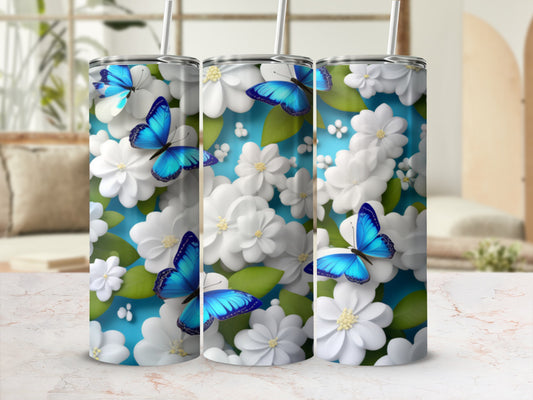 Three tumblers with blue butterflies and white flowers against a blue background.