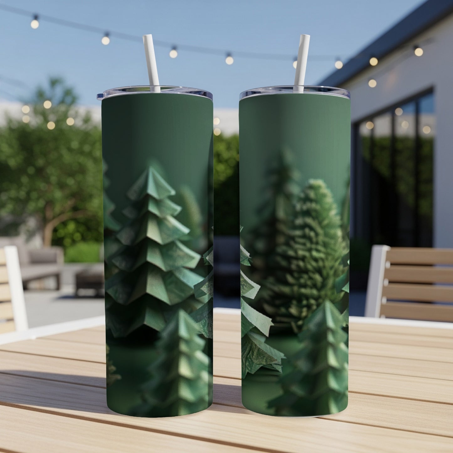 Two green tumblers with a forest of origami Christmas trees pattern.
