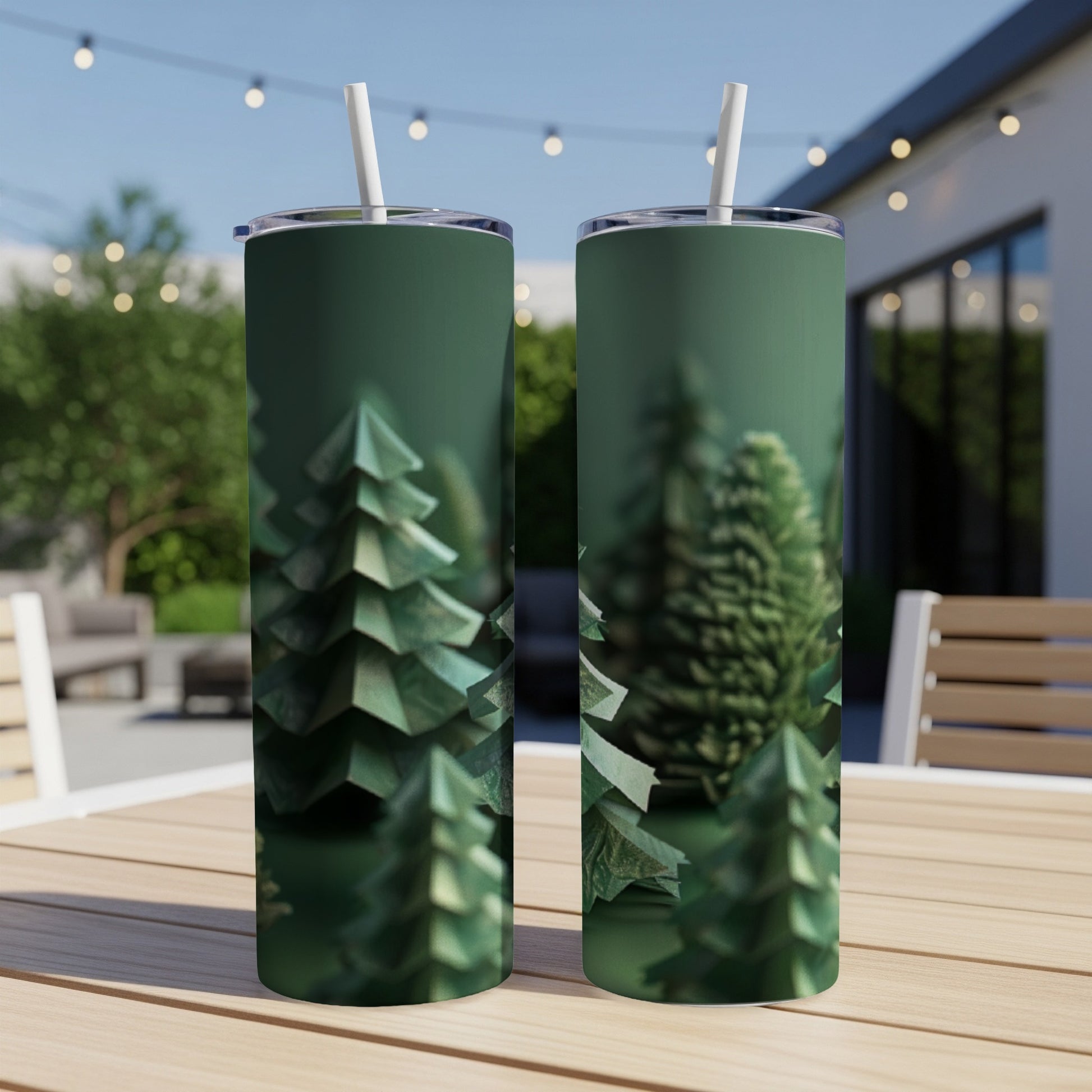 Two green tumblers with a forest of origami Christmas trees pattern.