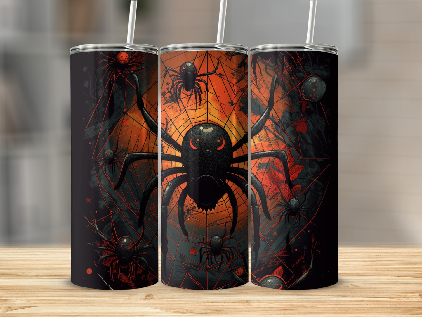Three tumblers with a black spider and web design on an orange background.