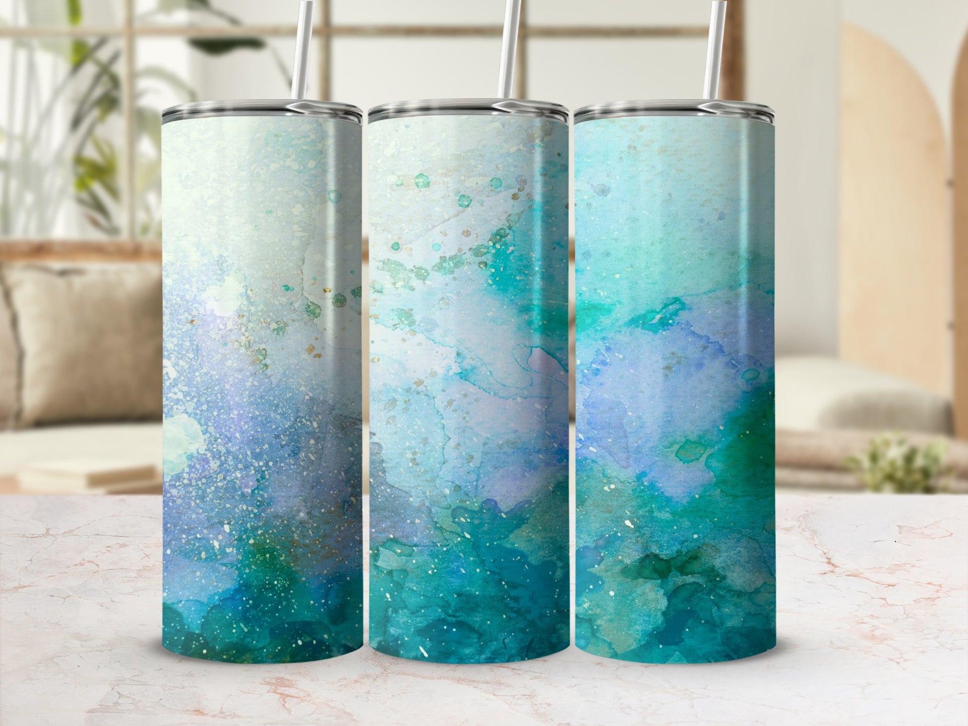 Three tumblers with blue and green watercolor abstract designs.