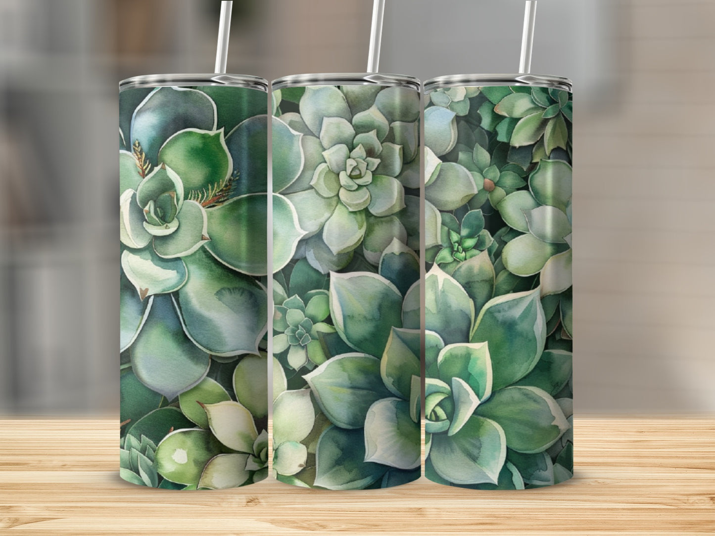 Three tumblers with a succulent plant pattern on a wooden surface.