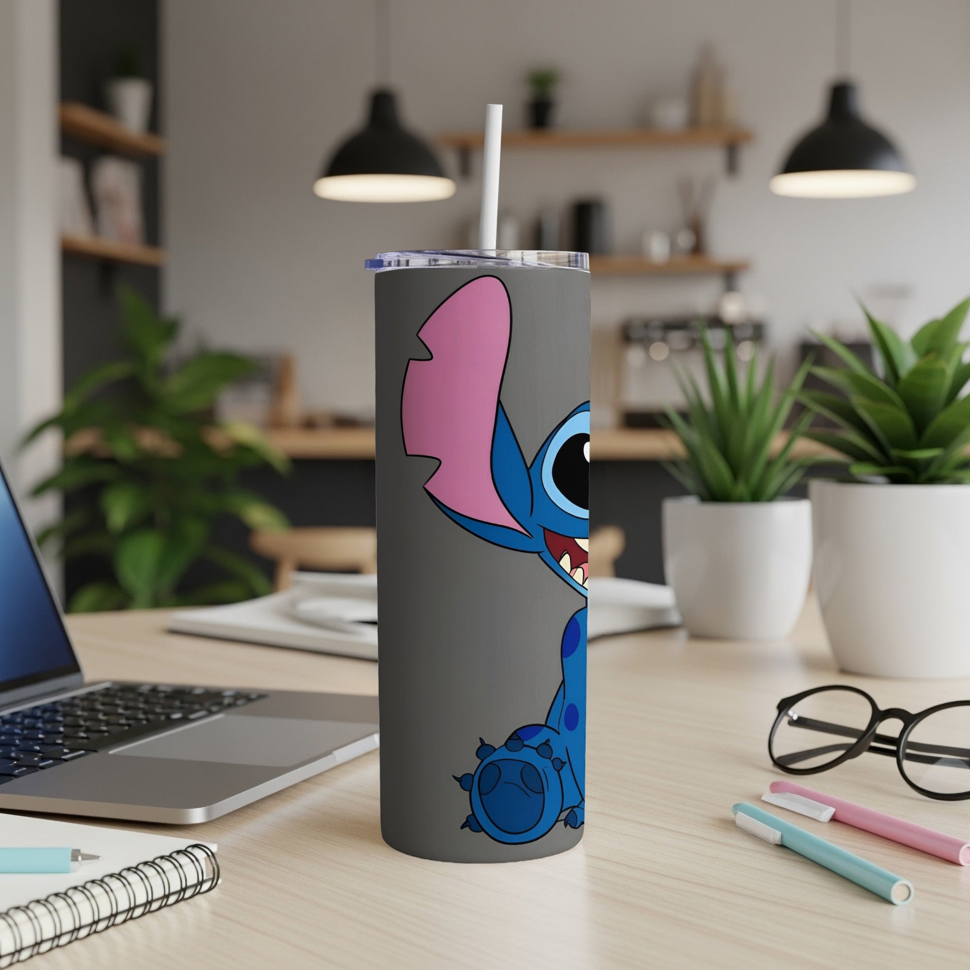 Stitch character design on a grey tumbler with a white straw.