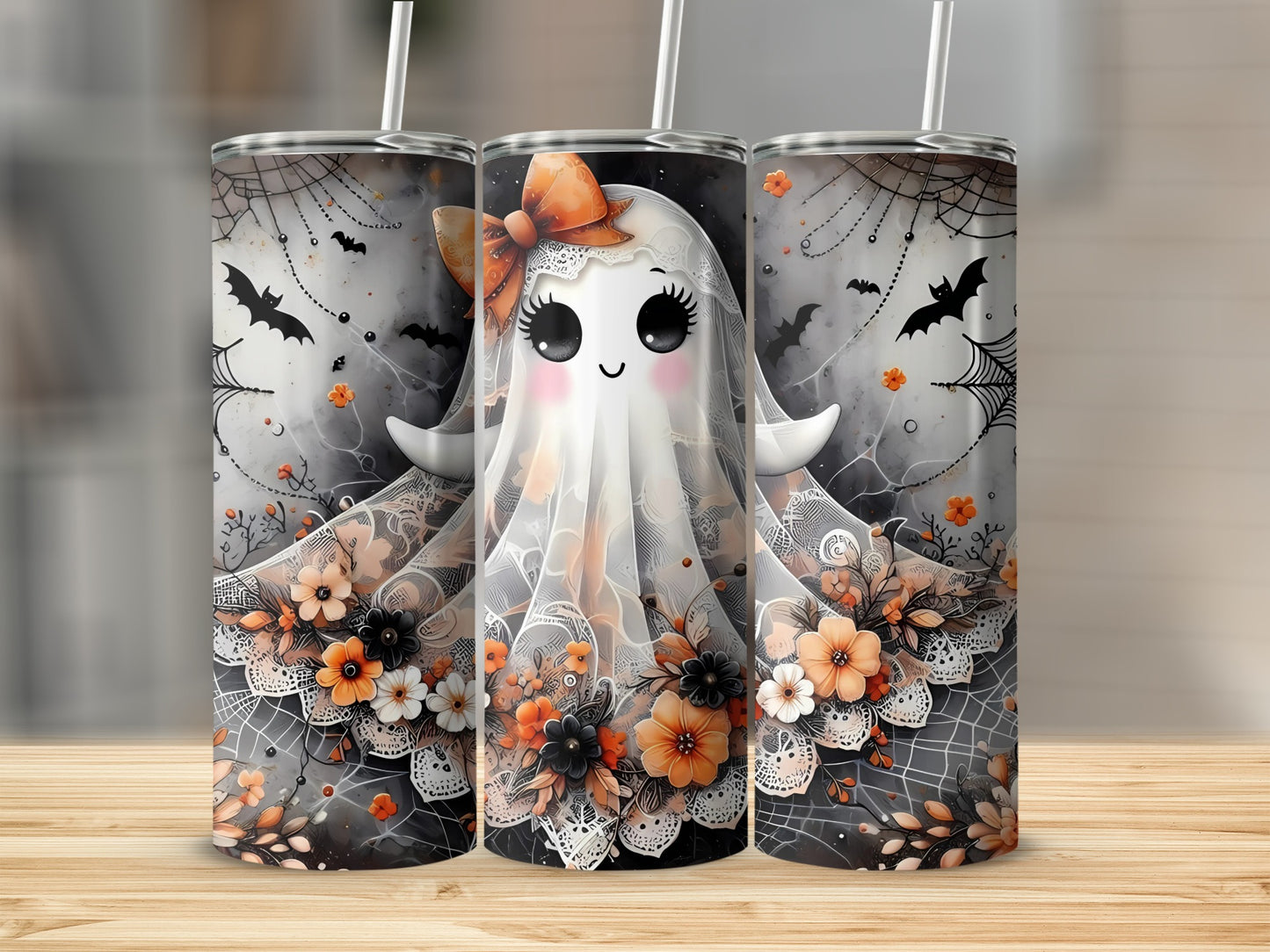 Three tumblers with a cute ghost design, Halloween bats, and orange flowers.