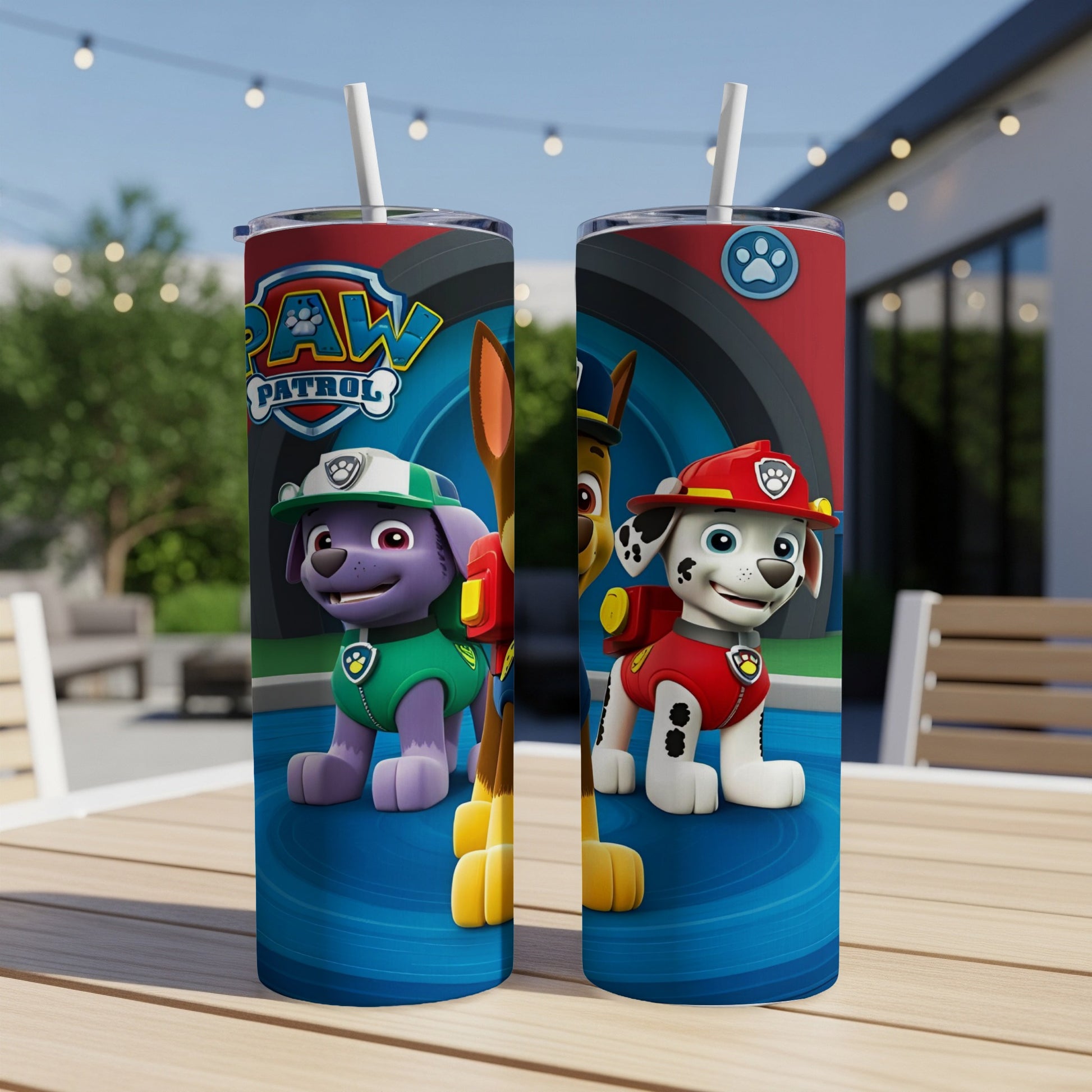 Paw Patrol characters Chase and Rubble on a blue, red, and white tumbler with straws.