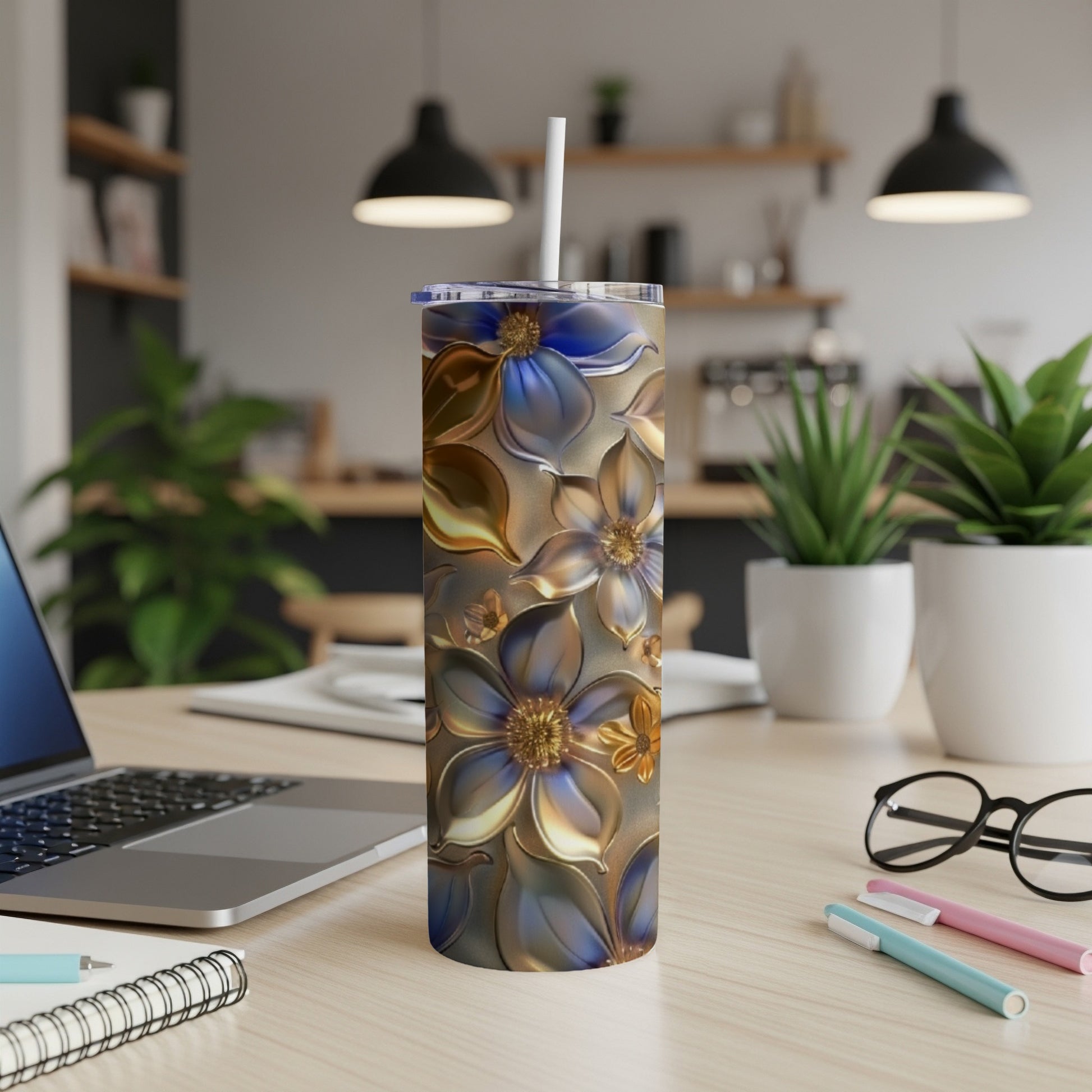 Silver and blue floral pattern on a tall, insulated tumbler with a straw.