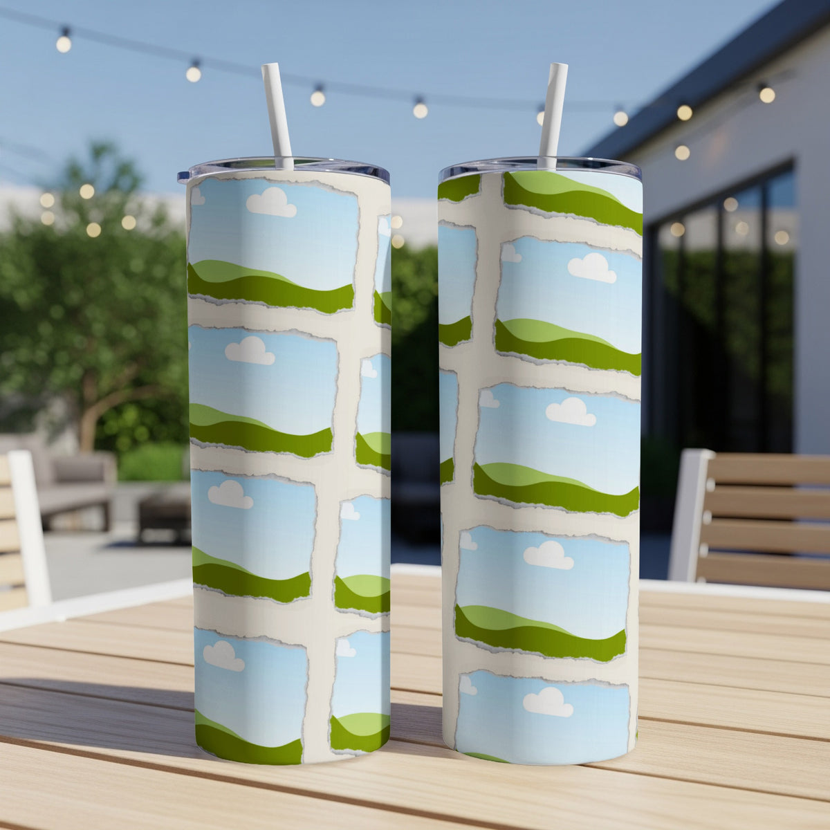 Two tumblers with ripped paper design featuring sky, clouds, and rolling green hills.