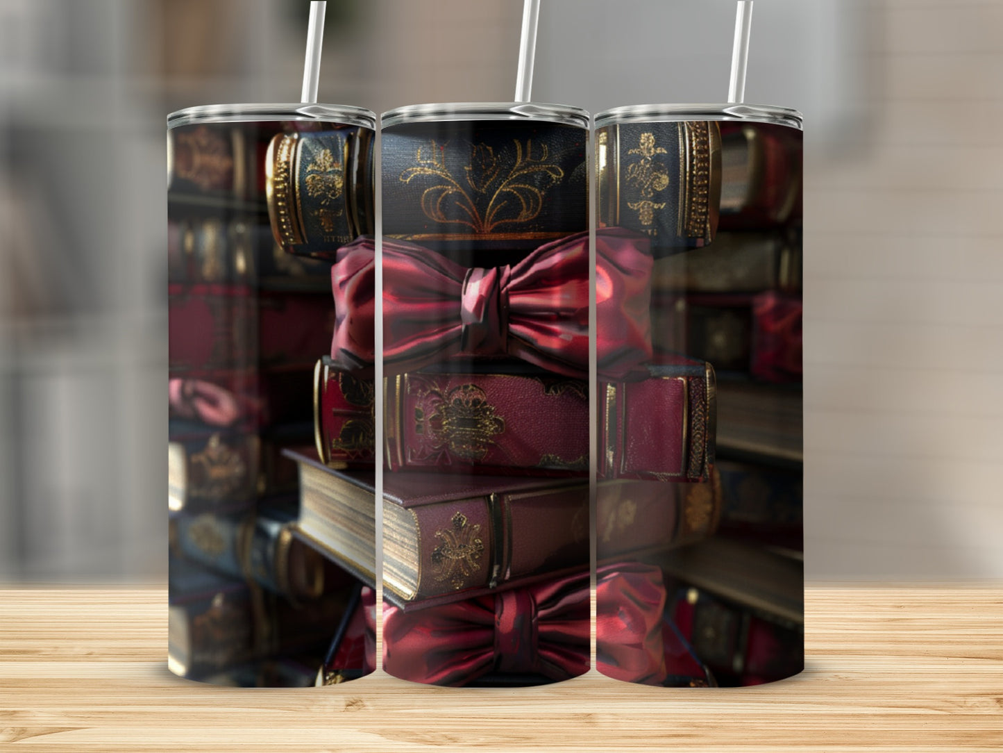 Three tumblers featuring vintage books and red bows on a wooden surface.