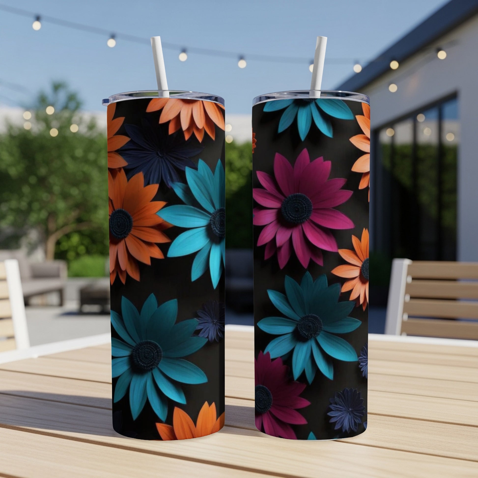 Two tumblers with colorful floral designs on a wooden table.